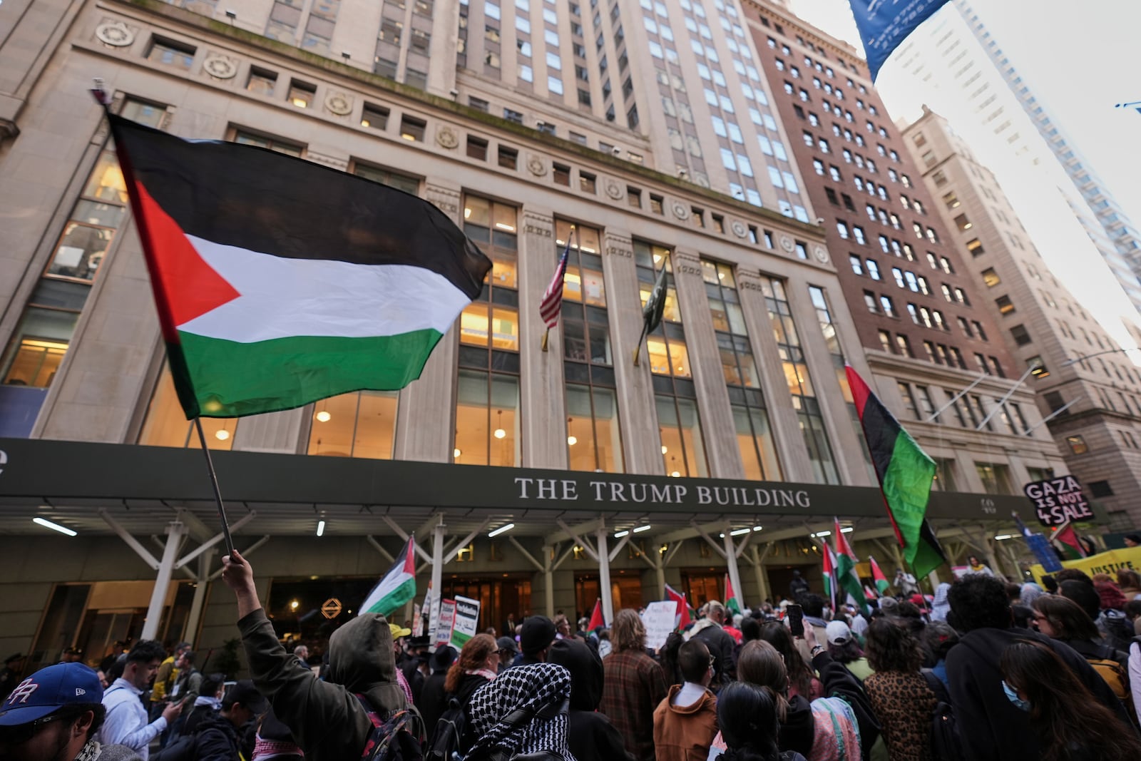 People gather to protest against Israel and President Donald Trump in front of a Trump-branded building Wednesday, March 19, 2025, in New York. (AP Photo/Frank Franklin II)