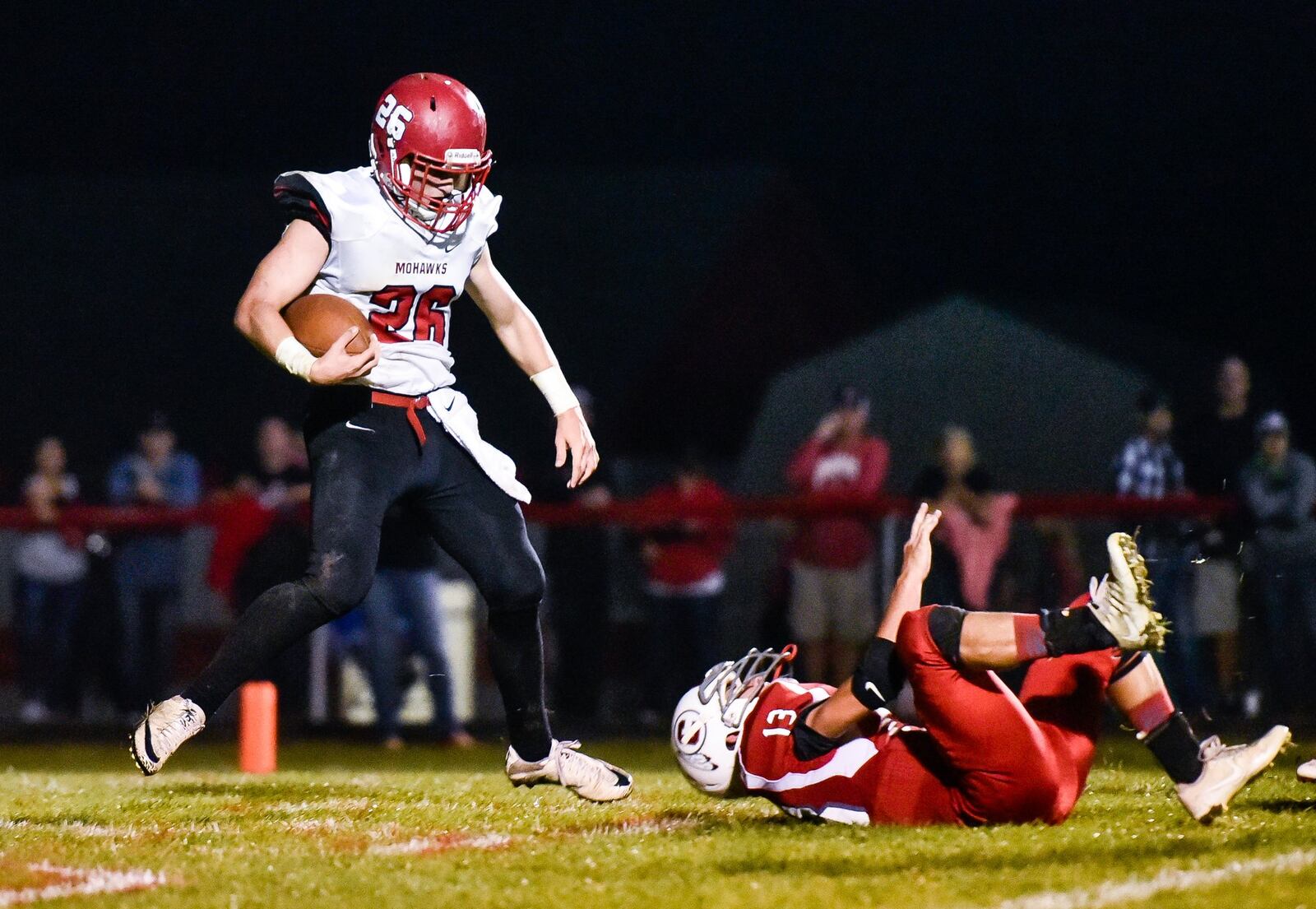 Madison’s Cameron Svarda gets past Carlisle’s Sammy Reed for a touchdown Oct. 6 at Carlisle’s Laughlin Field. The visiting Mohawks won 31-14. NICK GRAHAM/STAFF