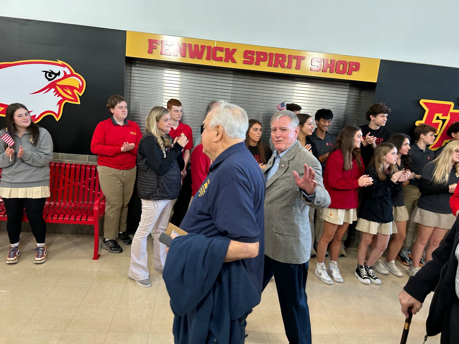 Mark Eckart, a 1969 Fenwick High School graduates, waves to the students who lined the halls to show their appreciation for the veterans after the school's annual Veteran's Day Breakfast. RICK McCRABB/CONTRIBUTOR