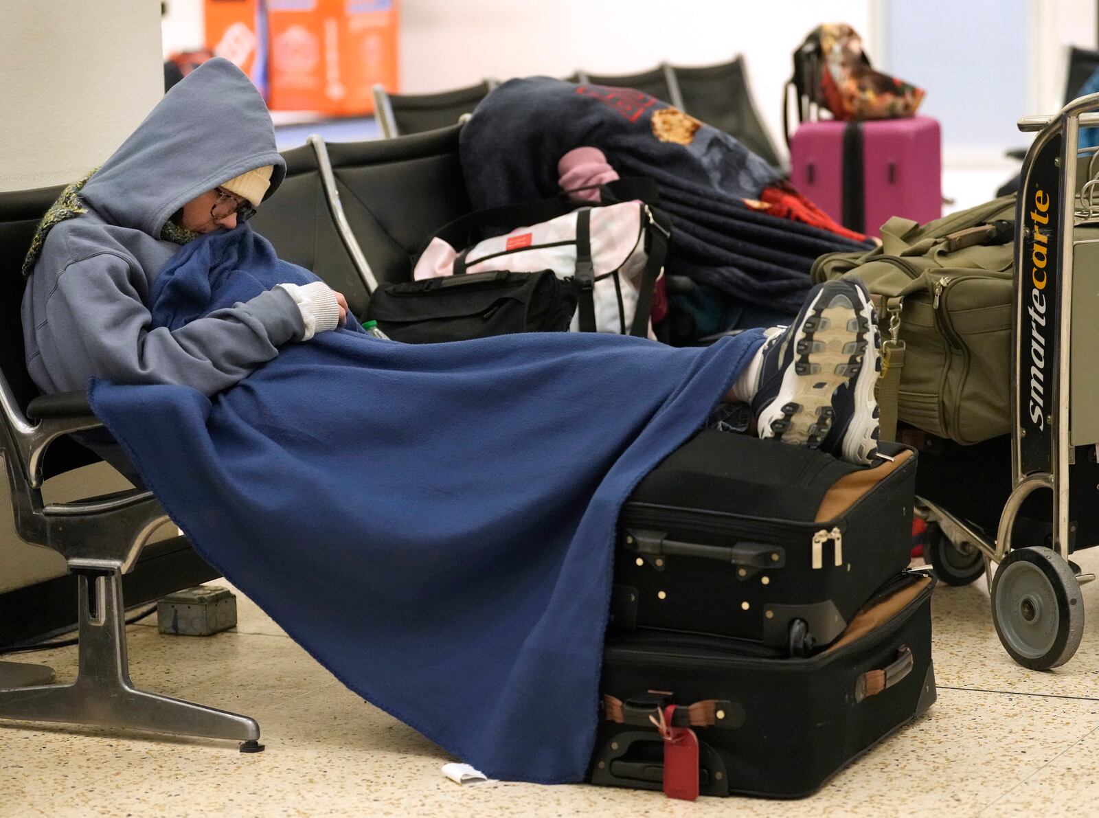 An unidentified woman who said she spent 2 nights in Terminal A at George Bush Intercontinental Airport is shown Wednesday, Jan. 22, 2025, in Houston. Both Houston airports reopened Wednesday after being closed on Tuesday due to the winter storm. (Melissa Phillip/Houston Chronicle via AP)