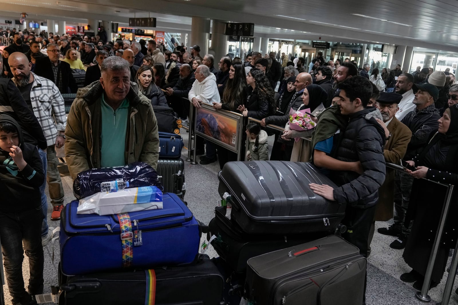 Travelers push their luggage as they arrive at Rafik Hariri International Airport, in Beirut, Lebanon, Friday, Feb. 21, 2025. (AP Photo/Bilal Hussein)