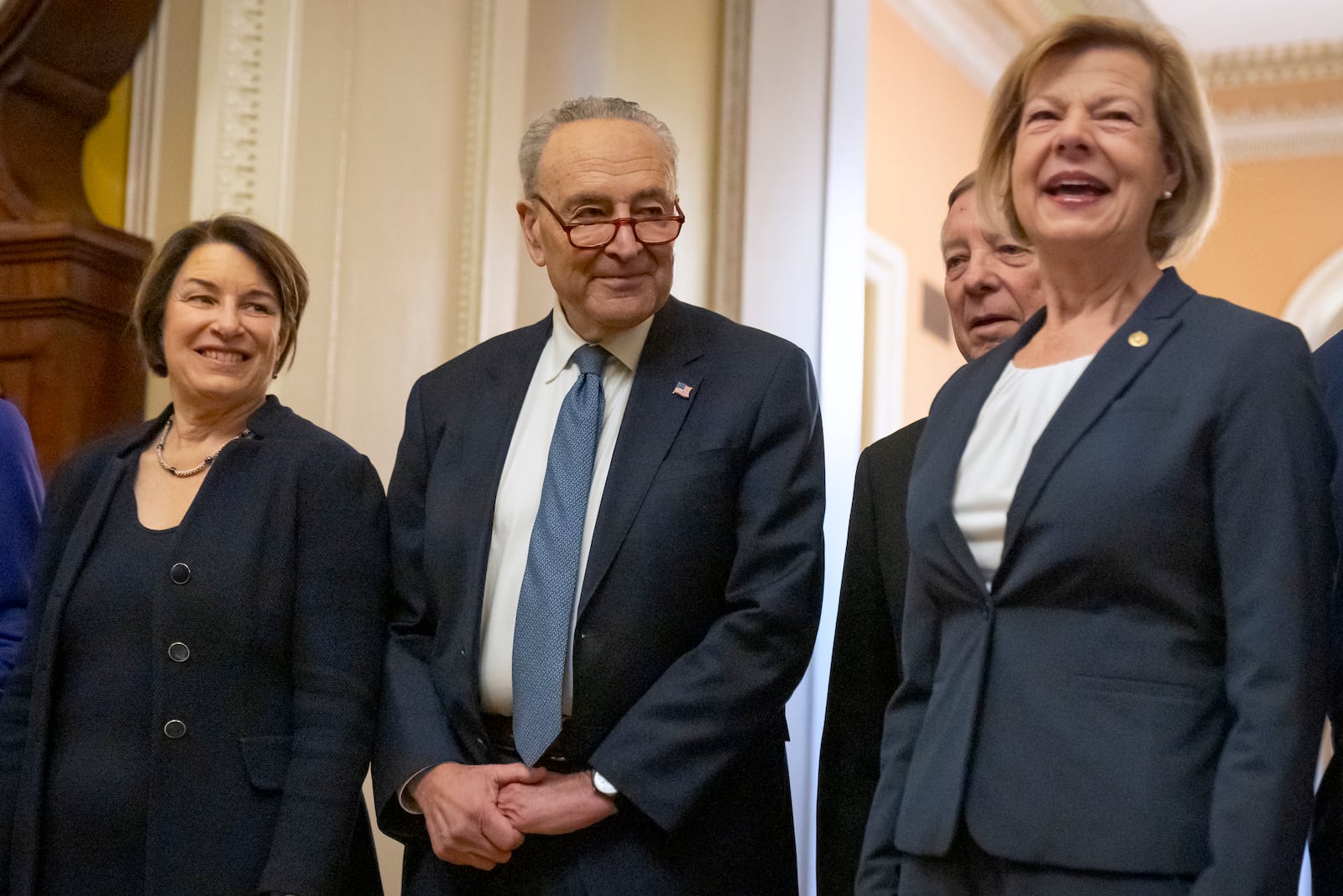 Senators, from left, Sen. Amy Klobuchar, D-Minn., Senate Majority Leader Chuck Schumer of N.Y., Sen. Dick Durbin, D-Ill., and Sen. Tammy Baldwin, D-Wis., gather after Senate Democratic leadership elections for the next session of Congress on Capitol Hill, Tuesday, Dec. 3, 2024, in Washington. (AP Photo/Mark Schiefelbein)