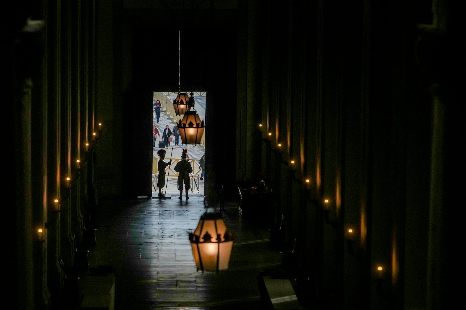 Vatican Swiss guards surveil the Bronze Door, the main entrance to the papal apartments, at The Vatican, Sunday, Feb. 23, 2025, as Pope Francis who was admitted over a week ago at Rome's Agostino Gemelli Polyclinic is in critical conditions. (AP Photo/Alessandra Tarantino)