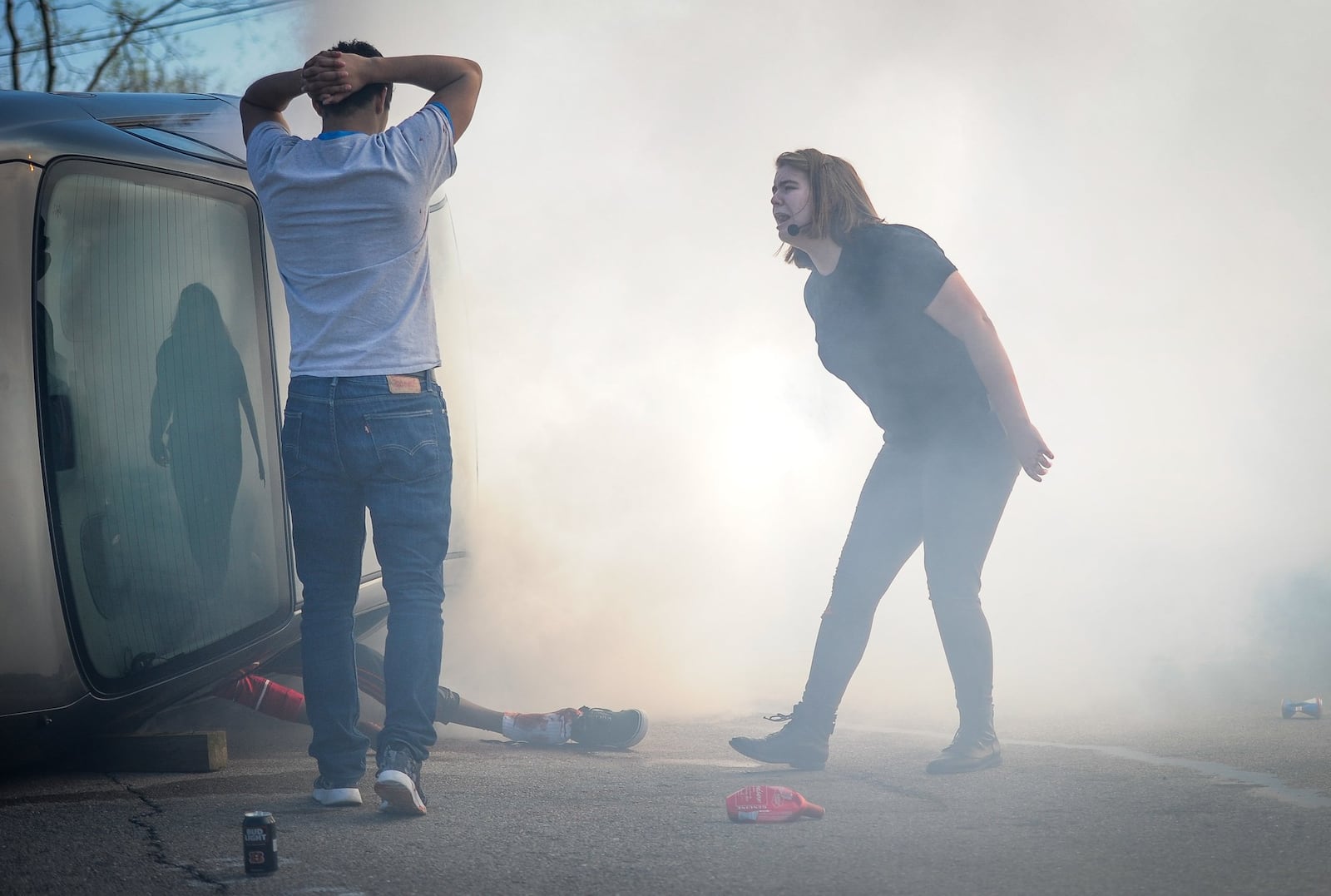 Hamilton High School senior Olivia Mueller, right, plays the role of hysterical friend as she yells at Alex Oseguera during a mock crash presented by The Greater Hamilton Safety Council to share with students the dangers of distracted driving Wednesday, April 12 at Hamilton High School. NICK GRAHAM/STAFF