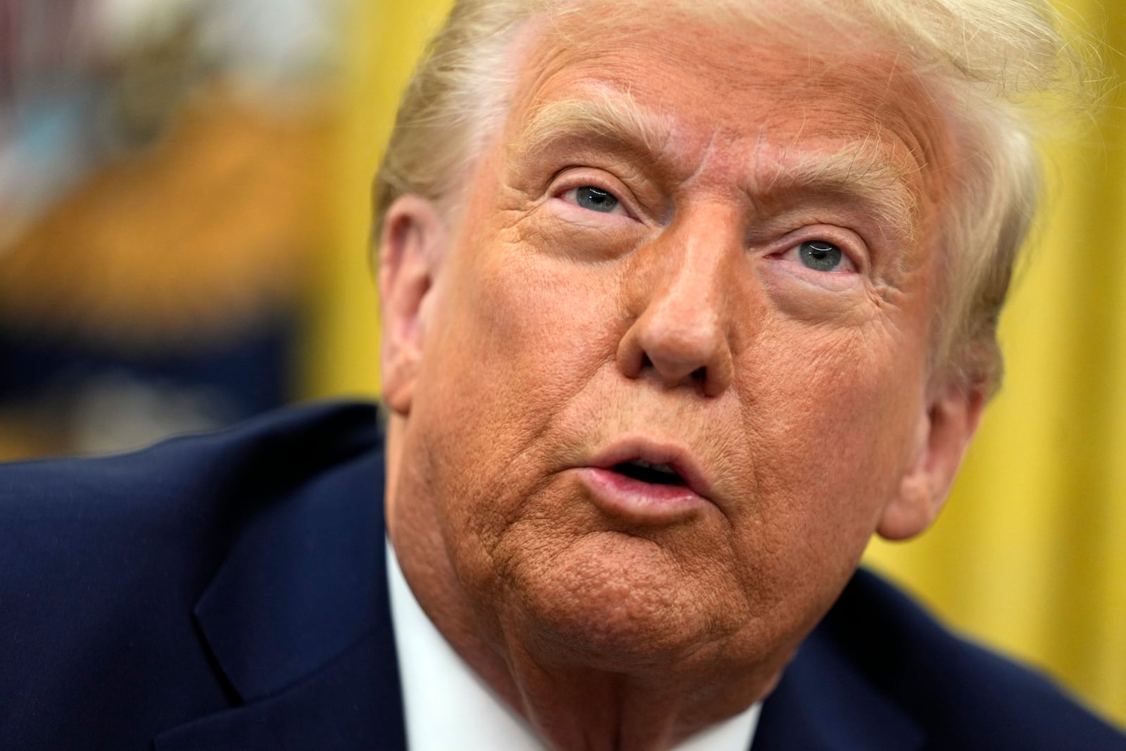 President Donald Trump talks to reporters as he signs executive orders in the Oval Office of the White House, Thursday, Jan. 23, 2025, in Washington. (AP Photo/Ben Curtis)