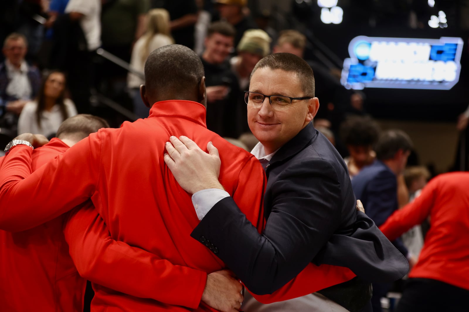 Dayton's Neil Sullivan celebrates with Anthony Grant after a victory against Nevada in the first round of the NCAA tournament on Thursday, March 21, 2024, at the Delta Center in Salt Lake City, Utah. David Jablonski/Staff