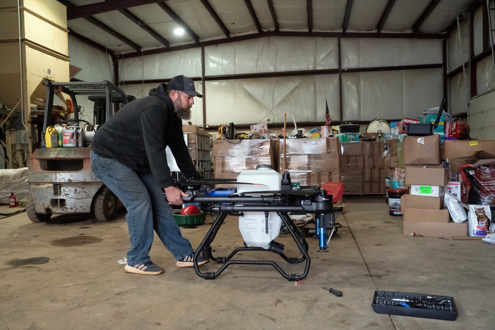 Russell Hedrick pulls out an EA Vision drone on his farm, Tuesday, Dec. 17, 2024, in Hickory, N.C. (AP Photo/Allison Joyce)