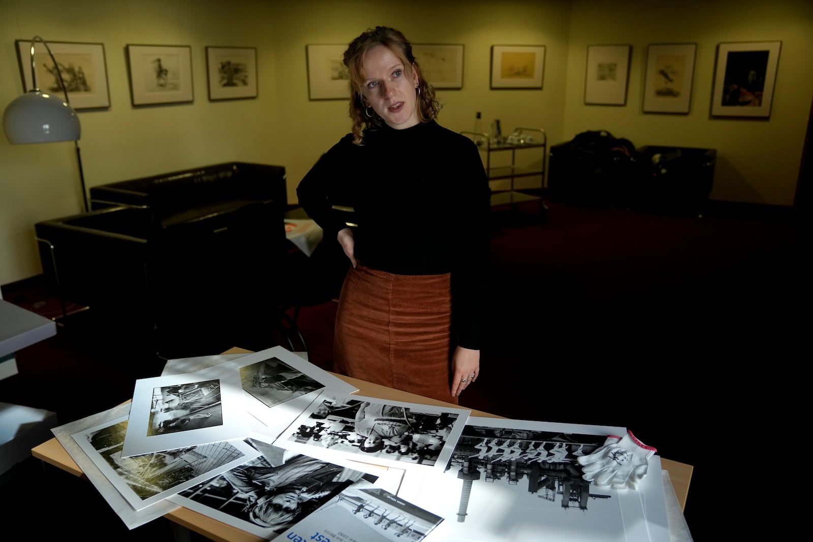 Clara Marz an Organizer of an exhibition about women works on the photos in her office in Berlin, Germany, Thursday, Oct. 17, 2024. (AP Photo/Ebrahim Noroozi)