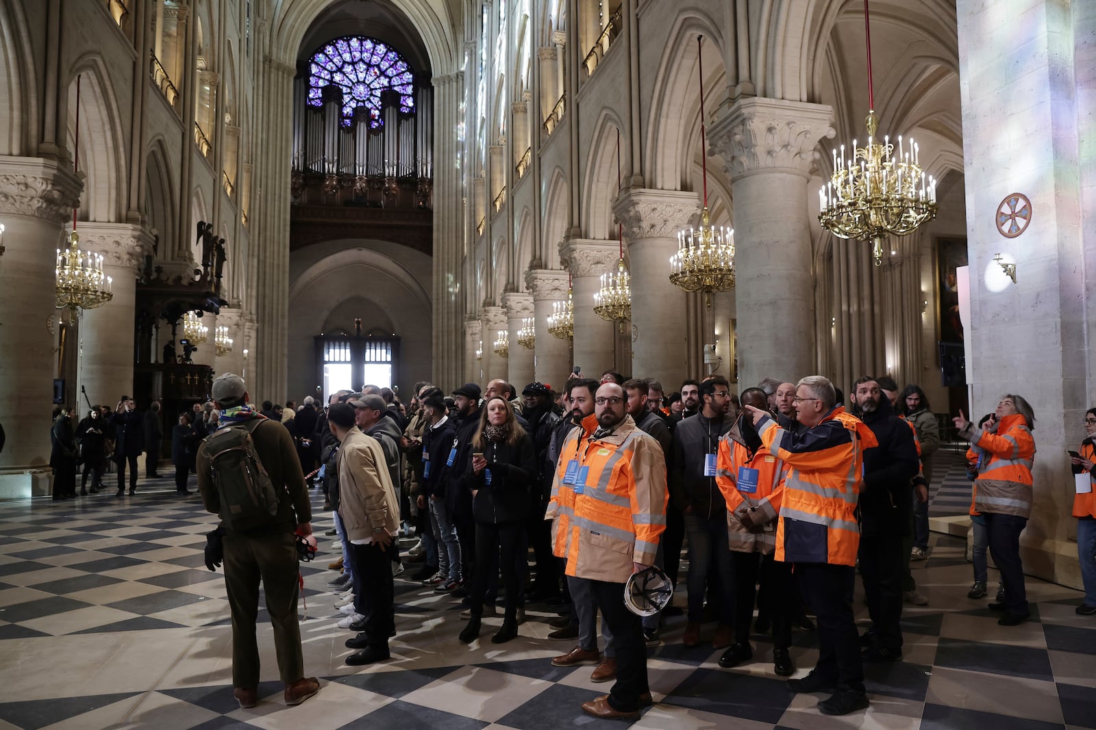 Construction workers who took part to the Notre-Dame cathedral restoration visit the cathedral after French President Emmanuel Macron's visit of the restored interiors, Friday, Nov.29, 2024 in Paris. (Christophe Petit Tesson, Pool via AP)