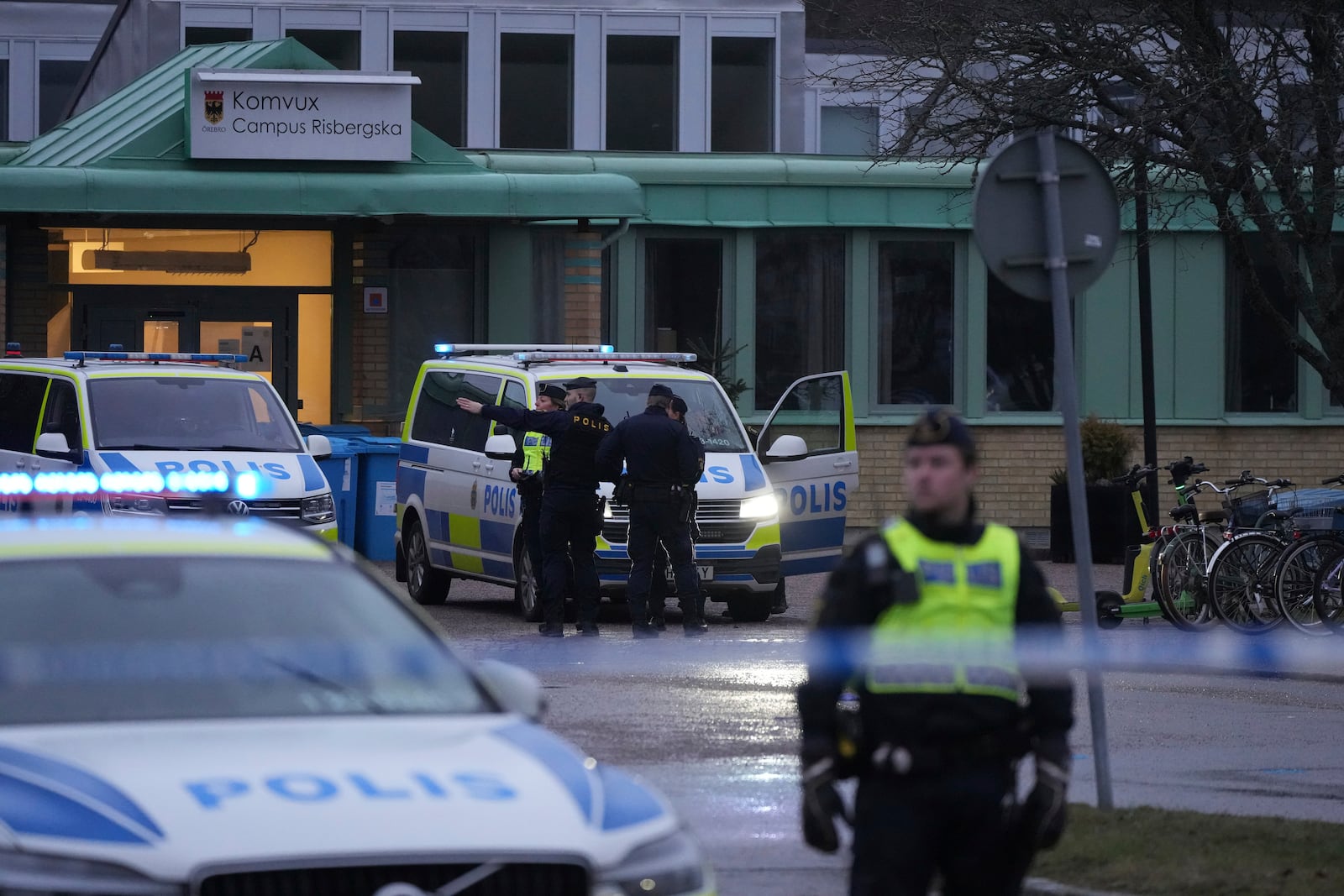 Police officers stand guard near the scene of a shooting at an adult education center on the outskirts of Orebro, Sweden, Wednesday, Feb. 5, 2025. (AP Photo/Sergei Grits)