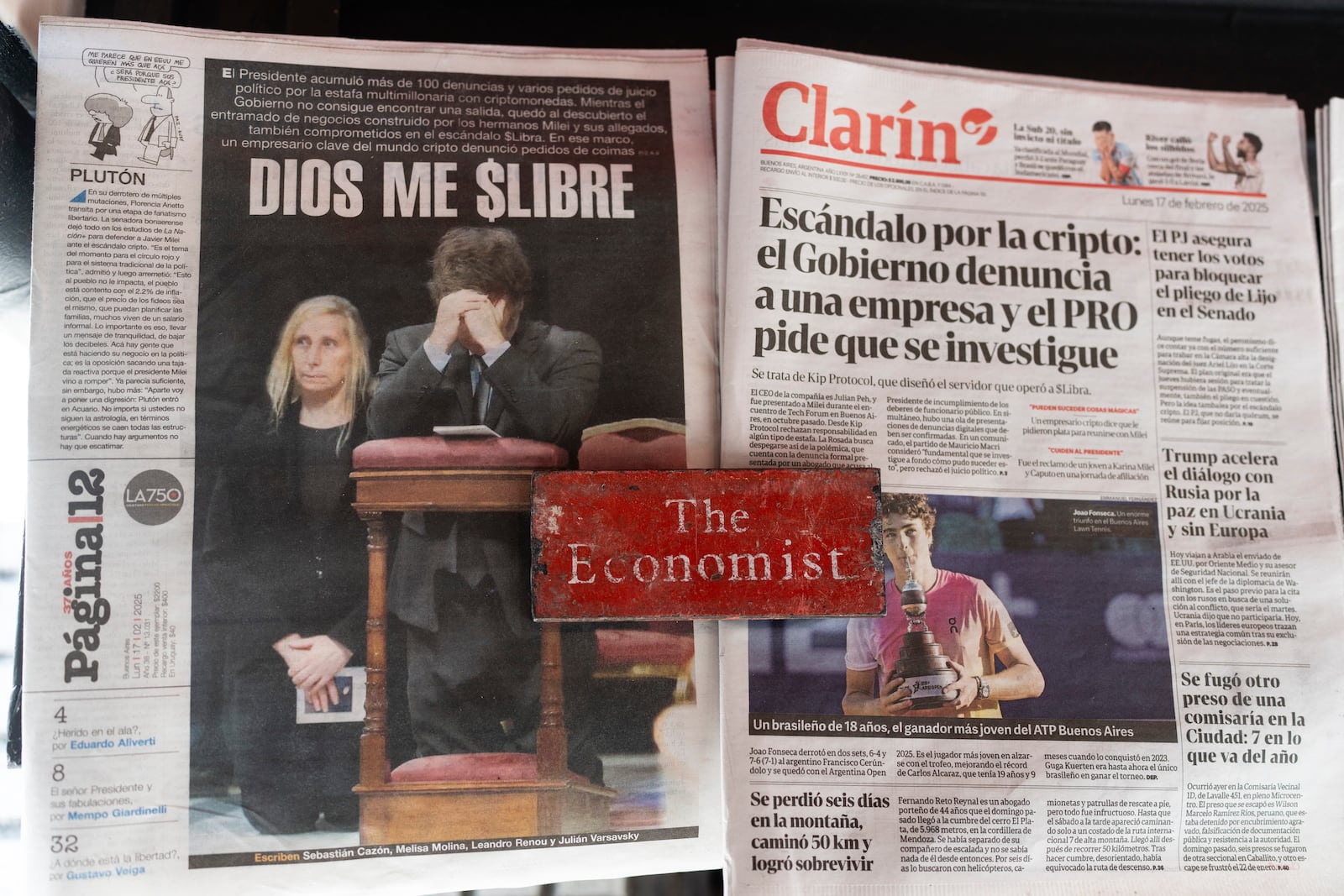 The national newspapers Clarin, right, and Pagin 12, left, are displayed for sale at a newsstand outside La Casa Rosada presidential office carrying headlines on a cryptocurrency scandal involving President Javier Milei in Buenos Aires, Argentina, Monday, Feb. 17, 2025. (AP Photo/Rodrigo Abd)