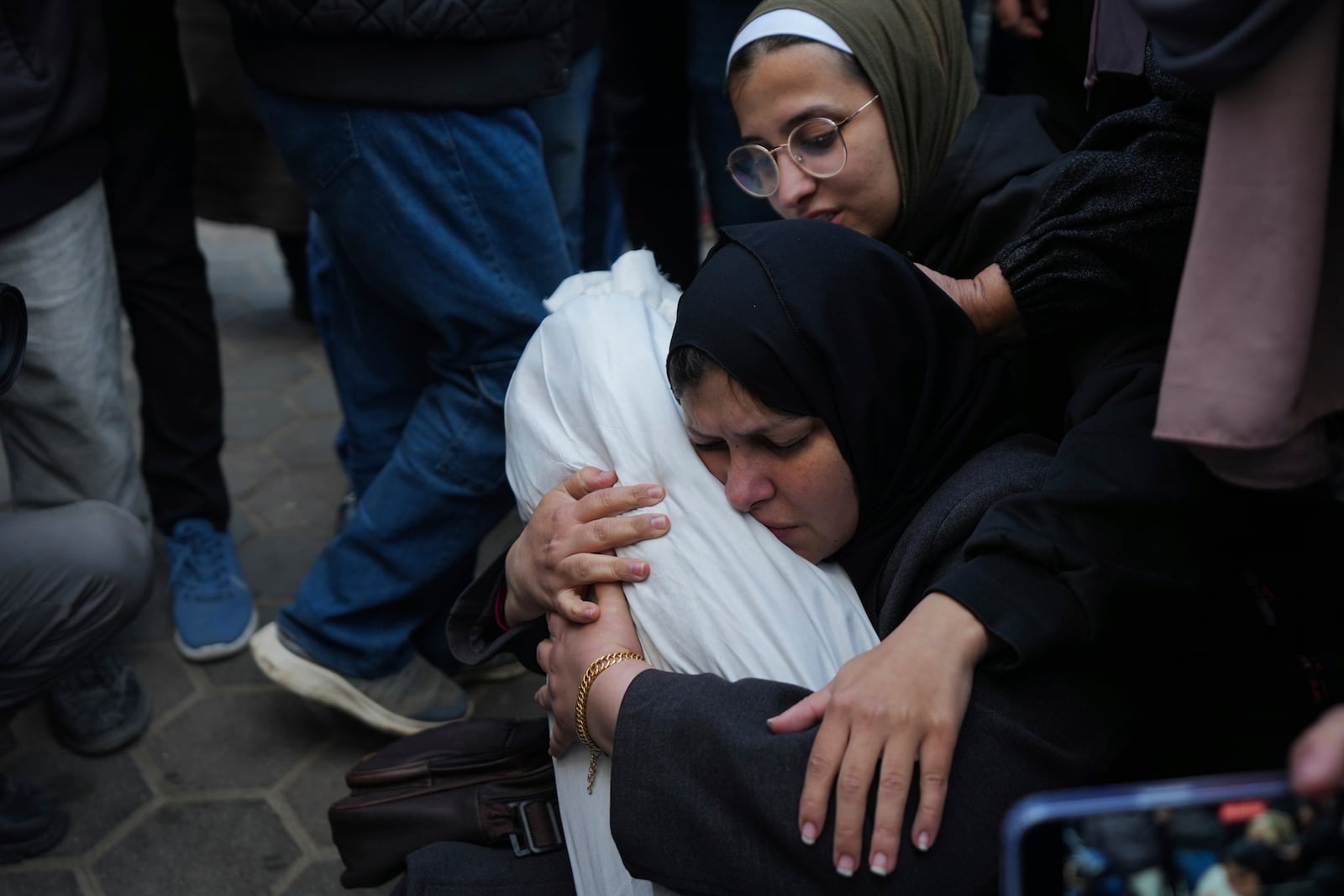 Hanan Shaqoura embraces the body of her son, Mohammad, 7, who was killed in the Israeli bombardment of the Gaza Strip, during his funeral in Deir al-Balah, Wednesday, Jan. 15, 2025. (AP Photo/Abdel Kareem Hana)