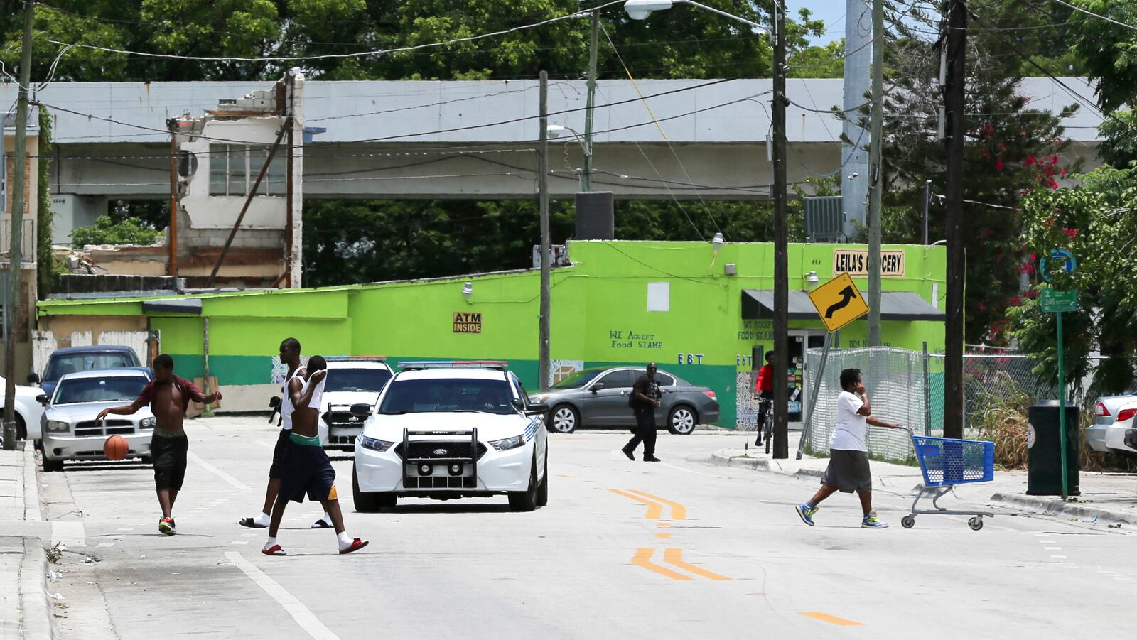 Police patrol a side street next to an apartment building where a 10-year-old boy that died of a fentanyl overdose last month lived, in Miami, Fla. (AP Photo/Mario Houben)