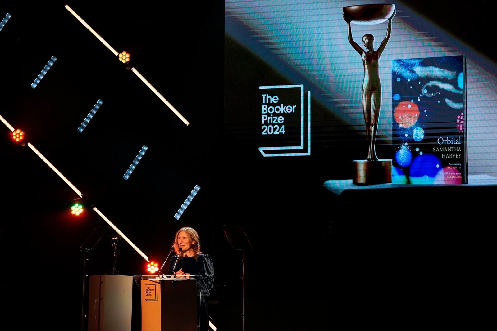 Samantha Harvey speaks on stage after winning the Booker Prize award 2024, in London, Tuesday, Nov. 12, 2024. (AP Photo/Alberto Pezzali)