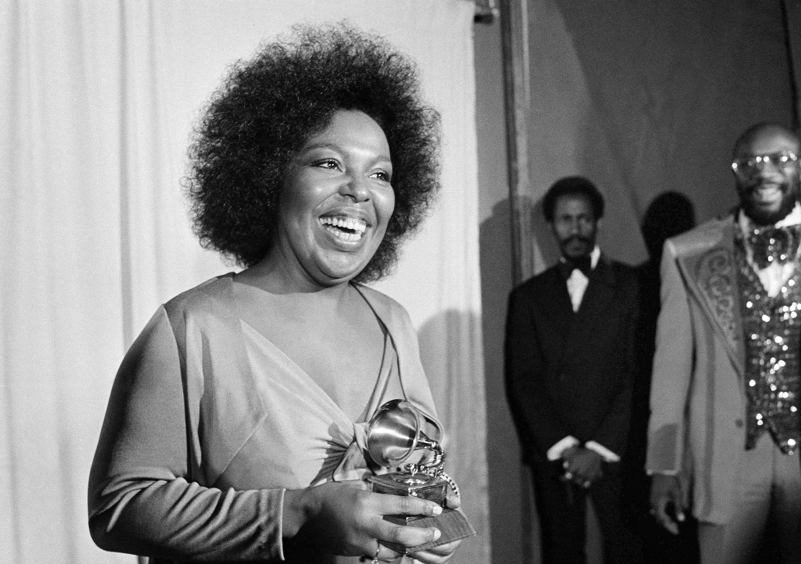 FILE - Roberta Flack holds the Grammy award for her record, "Killing Me Softly With His Song" as singer Isaac Hayes, right, looks on at the Grammy Awards in Los Angeles on March 4, 1974. (AP Photo/Harold Filan, File)