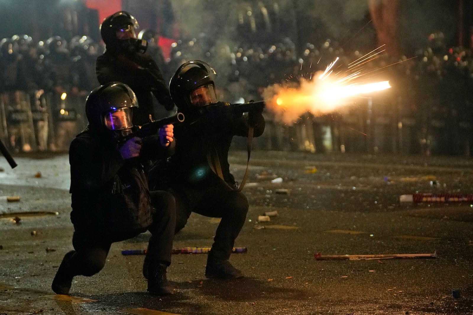 FILE - Police shoot tear gas towards demonstrators during a protest against the government's decision to suspend negotiations on joining the European Union in Tbilisi, Georgia, early Wednesday, Dec. 4, 2024. (AP Photo/Pavel Bednyakov, File)