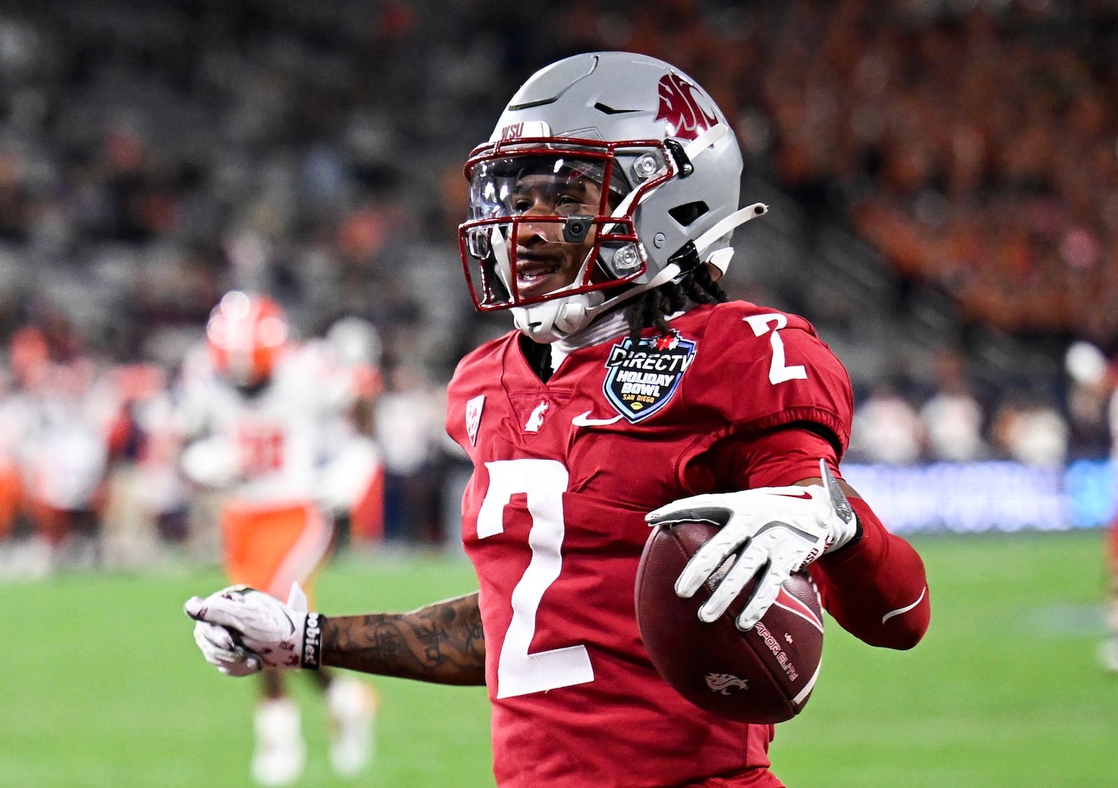 Washington State wide receiver Kyle Williams (2) celebrates after scoring on a pass reception during the first half of the Holiday Bowl NCAA college football game against Syracuse Friday, Dec. 27, 2024, in San Diego. (AP Photo/Denis Poroy)