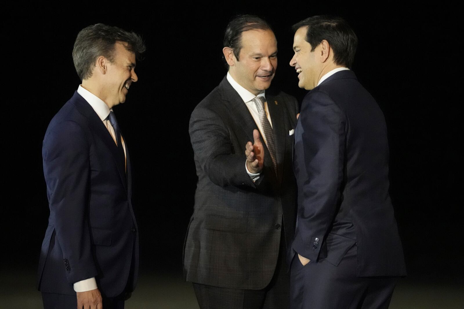 Secretary of State Marco Rubio, right, is received by Panamanian Foreign Minister Javier Martínez-Acha, center, and John Barrett, Chargé d'affaires, at the Panama Pacific International Airport in Panama City, Saturday, Feb. 1, 2025. (AP Photo/Mark Schiefelbein, Pool)