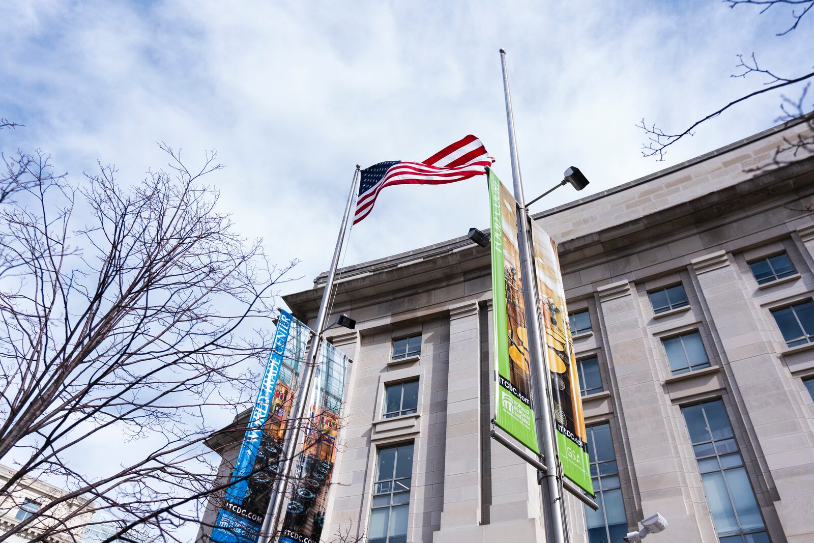 The American flag flies alone beside an empty flagpole previously flying the flag of the United States Agency for International Development, or USAID, in front the USAID headquarters in Washington, Friday, Feb. 7, 2025. (AP Photo/Manuel Balce Ceneta)