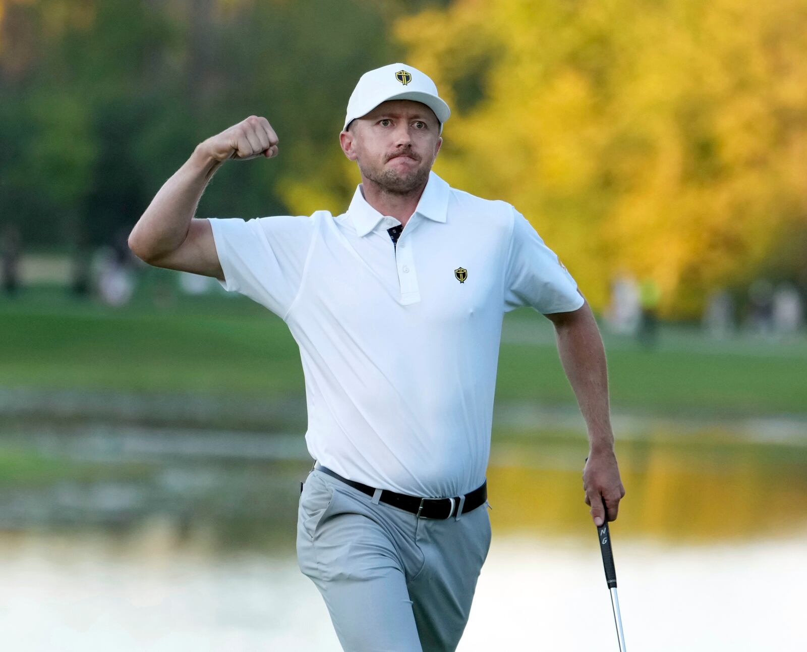 International team member Mackenzie Hughes, of Canada, reacts after his shot on the 17th hole during a fourth-round foursomes match at the Presidents Cup golf tournament at Royal Montreal Golf Club in Montreal, Saturday, Sept. 28, 2024. (Christinne Muschi/The Canadian Press via AP)