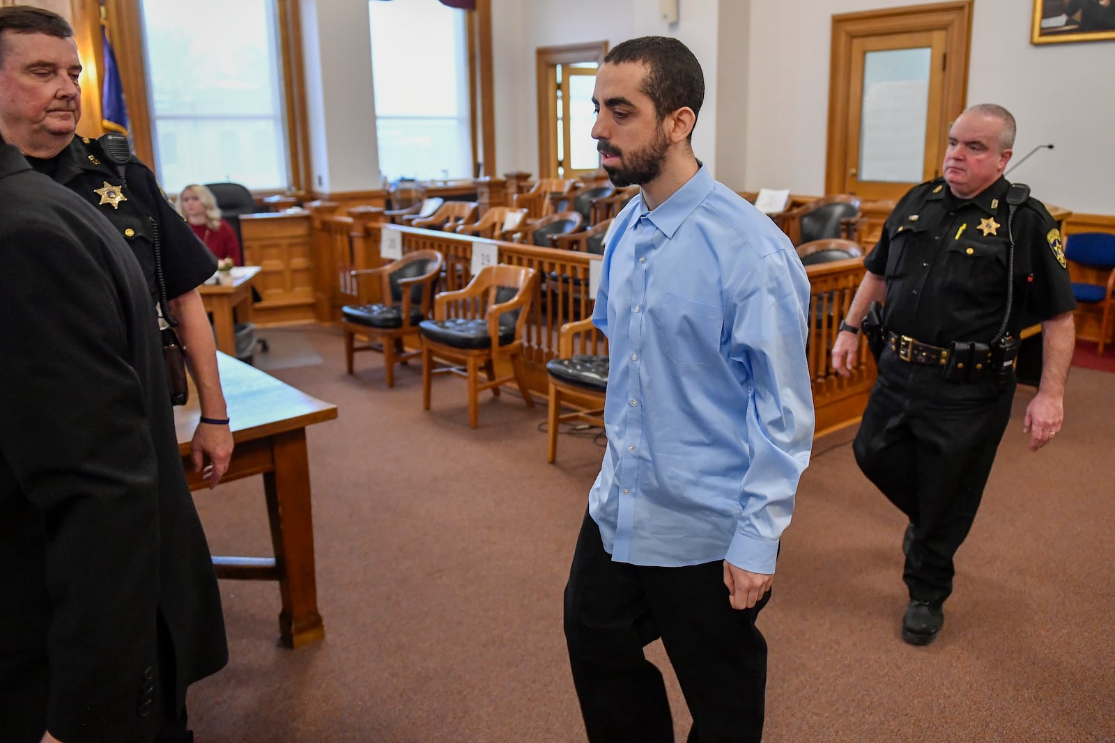 Hadi Matar, center, is led into Chautauqua County court before the start of jury selection in Mayville, N.Y., Tuesday, Feb. 4, 2025. Matar was indicted for the assault and attempted murder of author Salman Rushdie during an appearance at the Chautauqua Institution in 2022. (AP Photo/Adrian Kraus)