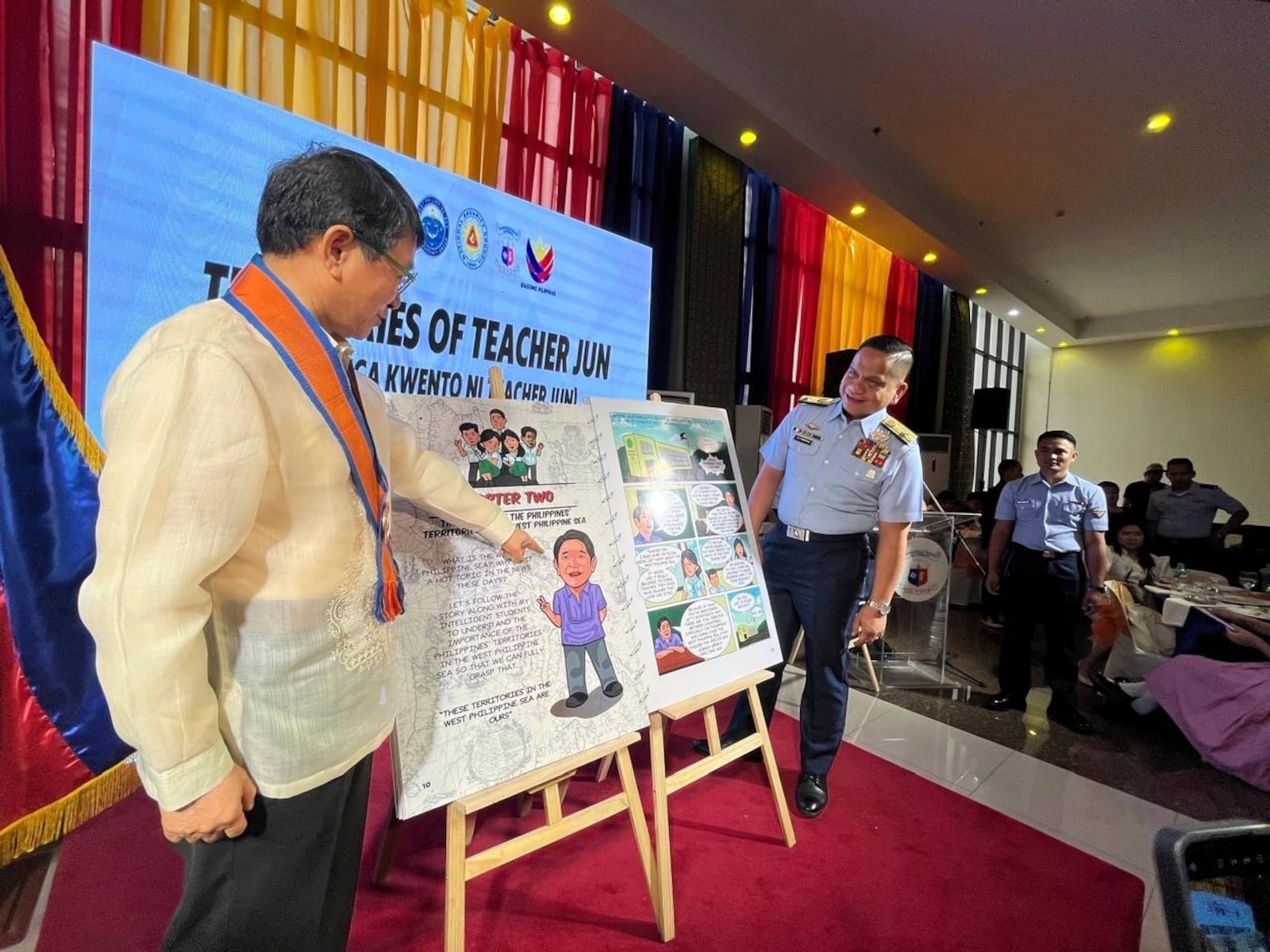 Philippine Coast Guard and national security officials launch comic books, titled "the Stories of Teacher Jun," that discuss the complex South China Sea territorial disputes in simple terms, highlights the Philippine position and criticizes China's aggressive actions, in Manila, Philippines, Friday Jan. 24, 2025. (AP Photo/Jim Gomez)