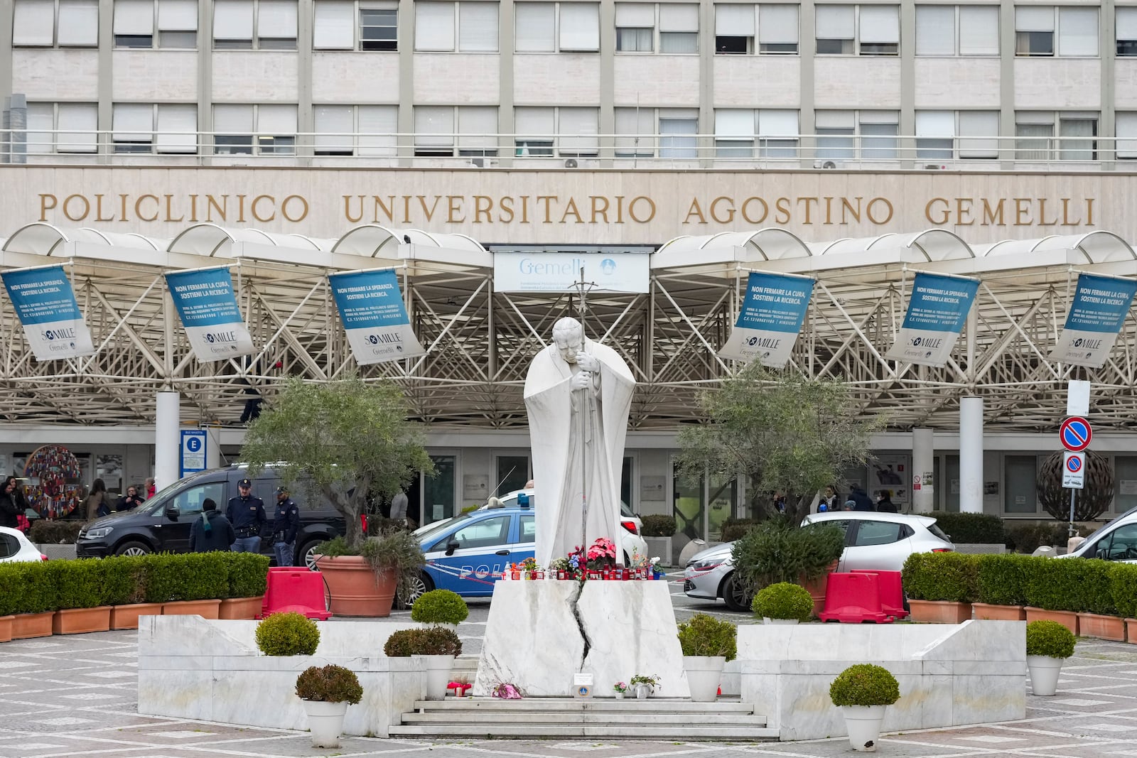 A statue of Pope John Paul II is seen in front of the Agostino Gemelli Polyclinic, in Rome, Tuesday, Feb. 18, 2025, where Pope Francis has been hospitalised to undergo some necessary diagnostic tests and to continue his ongoing treatment for bronchitis. (AP Photo/Andrew Medichini)