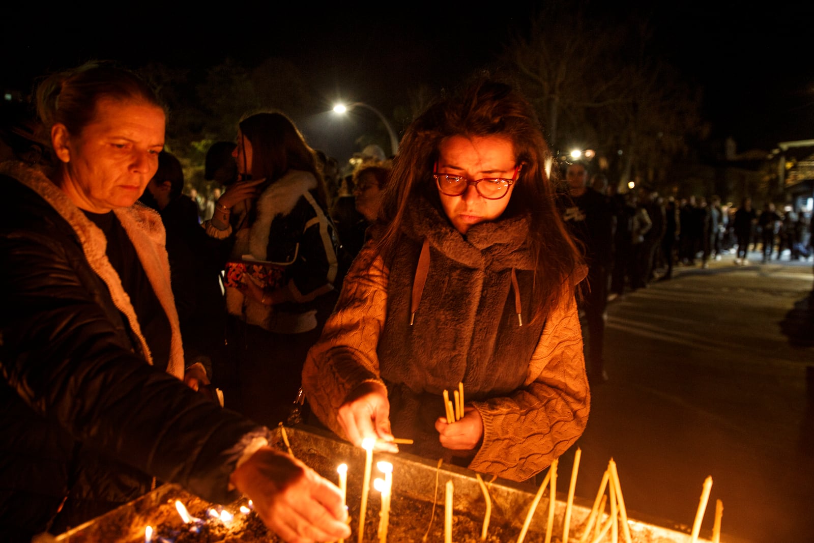 People wait in lines to light candles in the town of Kocani, North Macedonia, Sunday, March 16, 2025, following a massive fire in a nightclub early Sunday. (AP Photo/Visar Kryeziu)