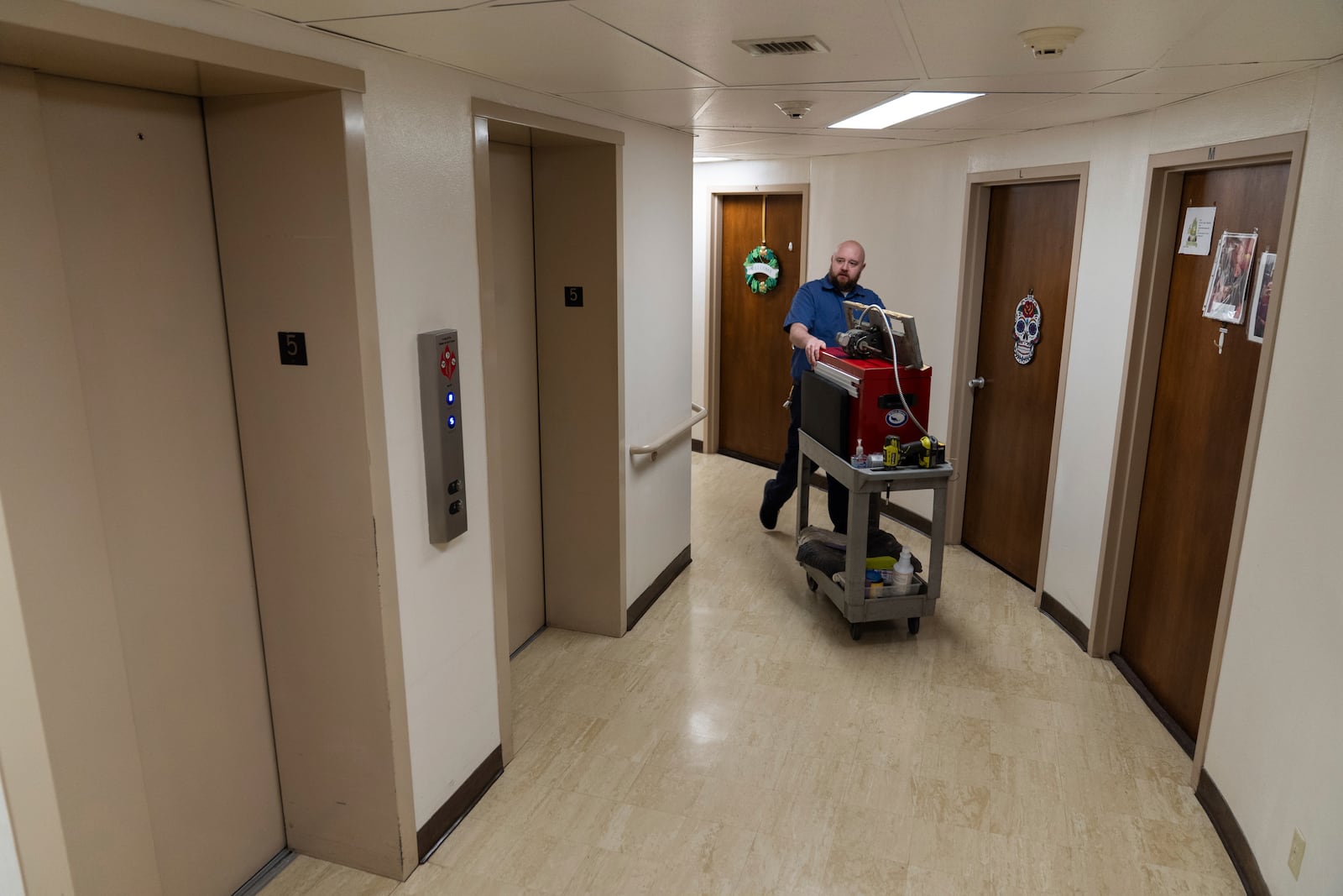 James Richardson walks to the elevator while doing repairs in Smith Tower Apartments on Monday, March 10, 2025, in Vancouver, Wash. (AP Photo/Jenny Kane)