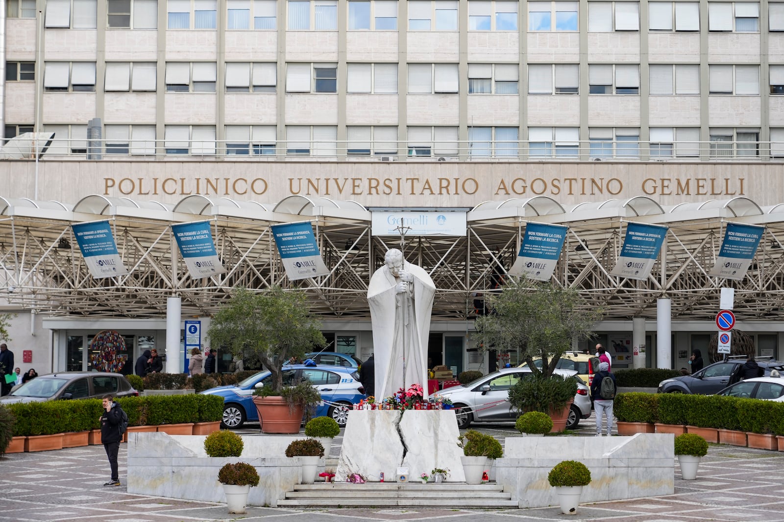 A statue of Pope John Paul II is seen in front of the Agostino Gemelli Polyclinic, in Rome, Monday, Feb. 17, 2025, where Pope Francis has been hospitalized to undergo some necessary diagnostic tests and to continue his ongoing treatment for bronchitis. (AP Photo/Andrew Medichini)