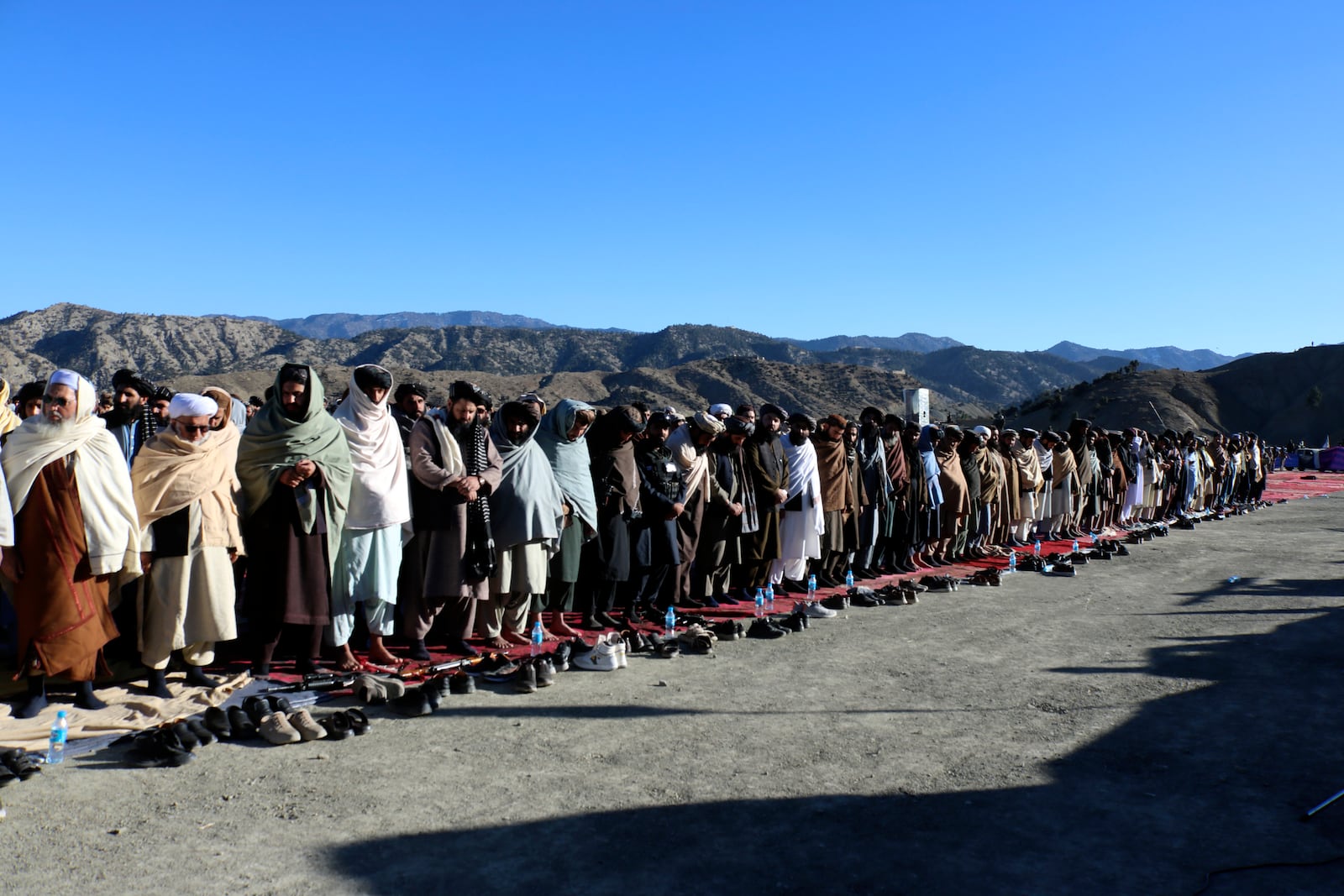 People attend the funeral prayer of Khalil Haqqani, the minister for refugees and repatriation, during his funeral procession in eastern Paktia province, Afghanistan, Thursday, Dec. 12, 2024. (AP Photo/Saifullah Zahir)