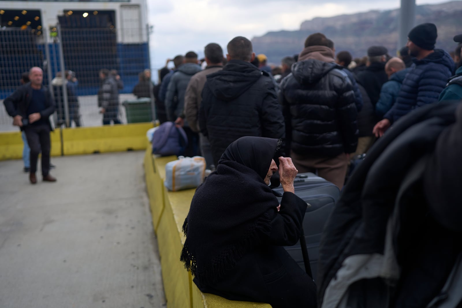 Flora, 94, said she survived a deadly earthquake on Santorini in 1956, as she boards a ferry bound for the Greek mainland, in the earthquake-struck Greek island, Tuesday, Feb. 4, 2025. (AP Photo/Petros Giannakouris)