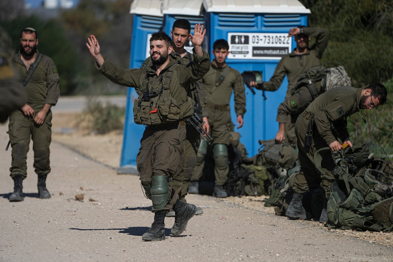 Israeli soldiers are seen as they return from the Gaza Strip at the Israeli-Gaza border, Saturday, Jan. 18, 2025. (AP Photo/Tsafrir Abayov)