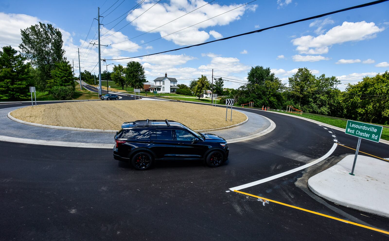 Vehicles drive around the roundabout at LeSourdsville West Chester Road and Beckett Road in West Chester Township Wednesday, August 19, 2020. This is the most recent roundabout to be competed in Butler County. NICK GRAHAM / STAFF