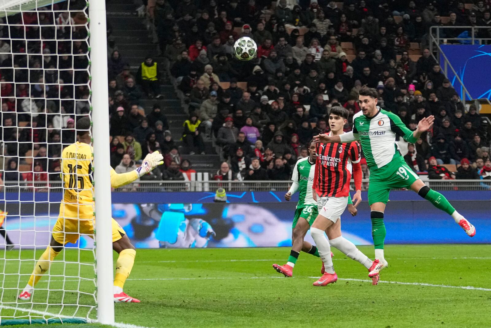 Feyenoord's Julian Carranza scores his side's first goal during Champions League, playoff second leg soccer match between AC Milan and Feyenoord, at the San Siro stadium in Milan, Italy, Tuesday, Feb.18, 2025. (AP Photo/Luca Bruno)