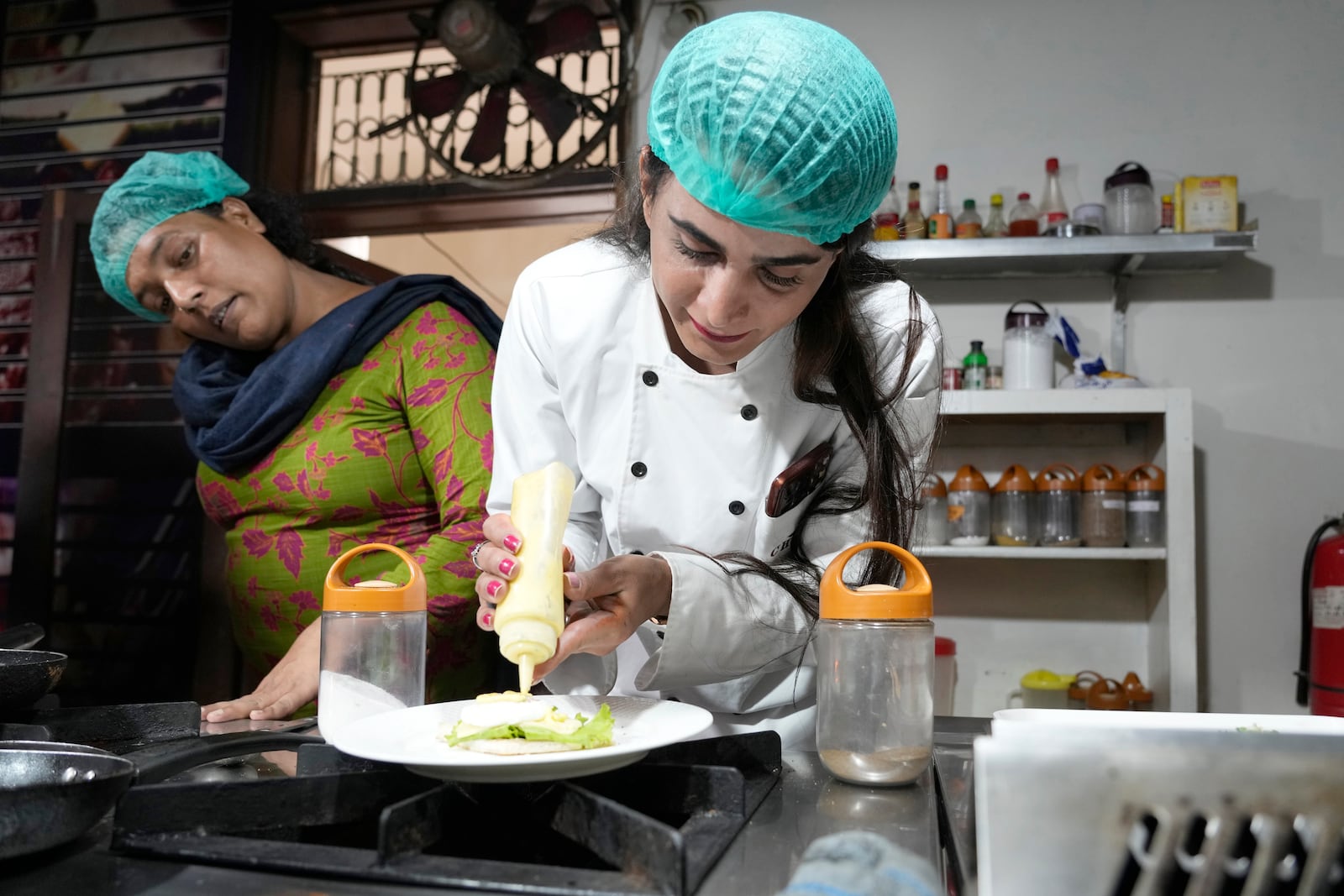 A transgender person attends cooking class at the Culinary & Hotel Institute of Pakistan, in Lahore, Pakistan, Tuesday, Feb. 25, 2025. (AP Photo/K.M Chaudary)