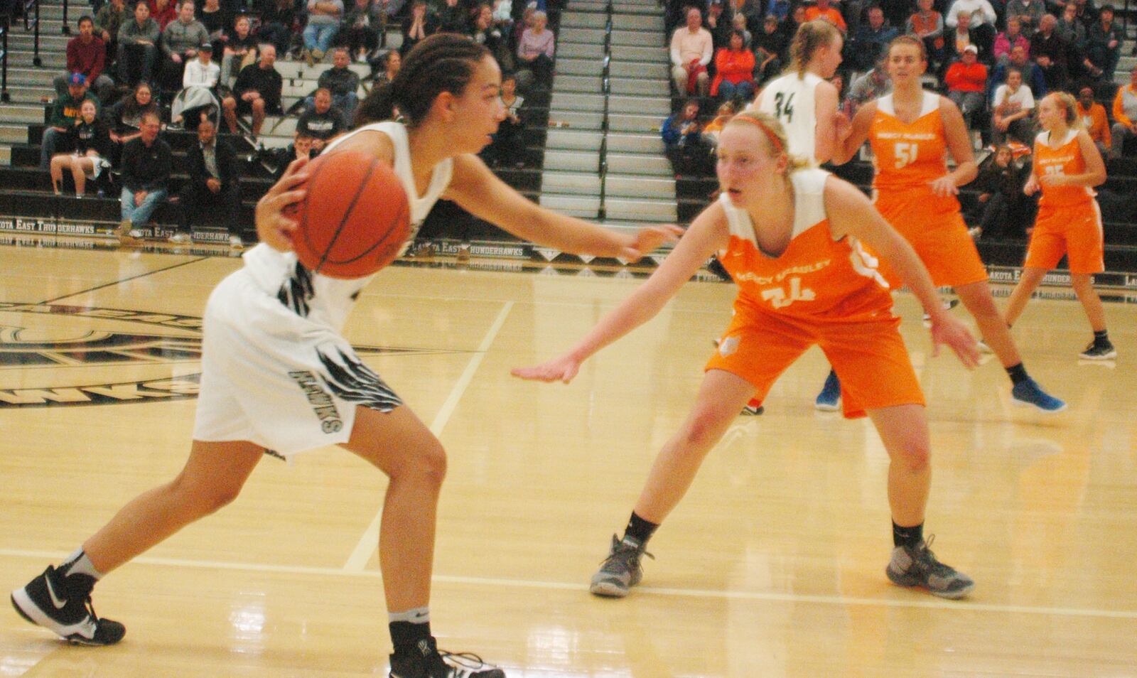 Lakota East's Jordan Stanley (13) is guarded by Mercy McAuley's Jenna Schoster (24) during Saturday afternoon's game in Liberty Township. Visiting Mercy McAuley won 48-26. RICK CASSANO/STAFF