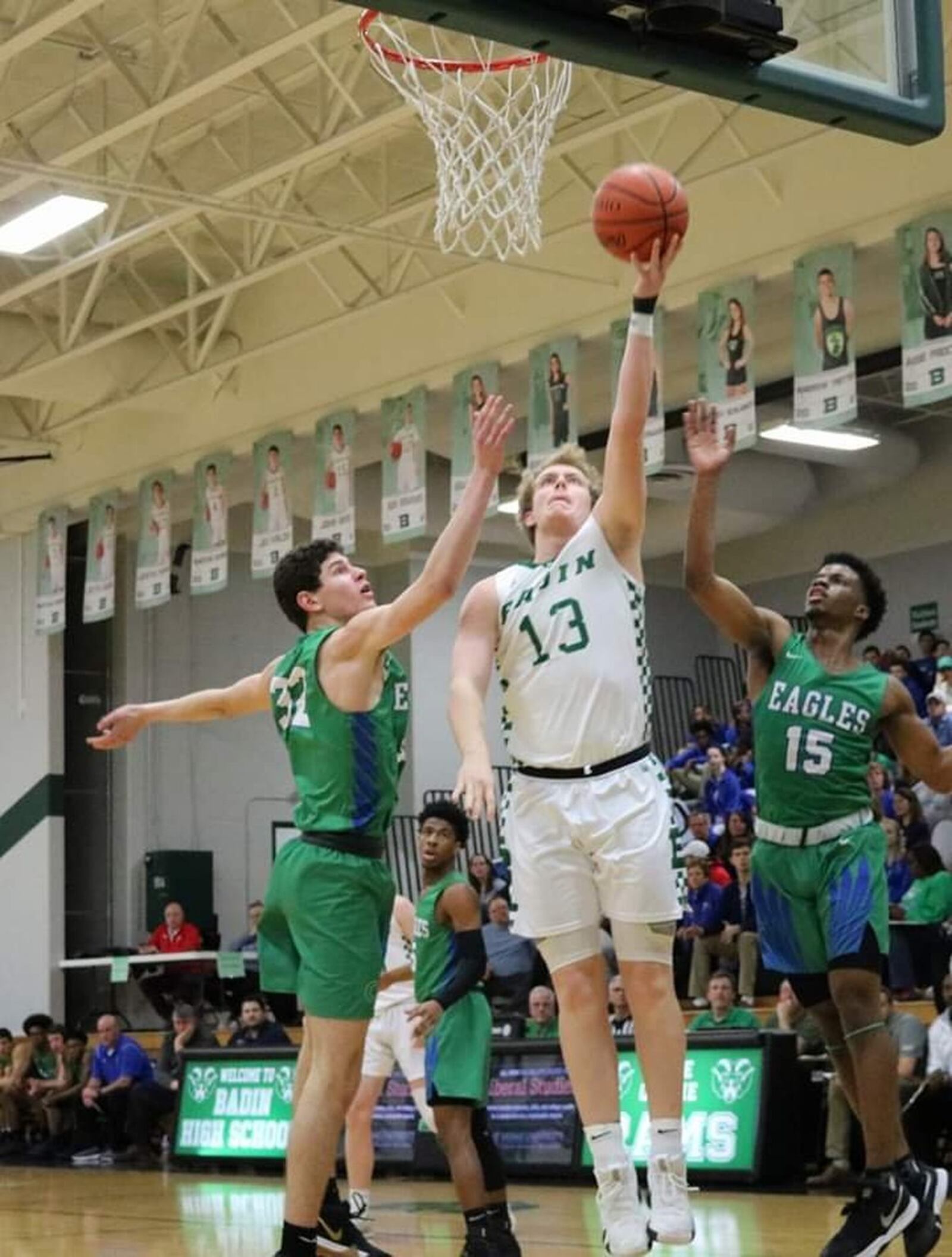 Badin’s Justin Pappas (13) shoots between Chaminade Julienne’s Dan Nauseef (32) and Milton Gage (15) during Friday night’s game at Mulcahey Gym in Hamilton. CJ won 58-54. CONTRIBUTED PHOTO BY TERRI ADAMS