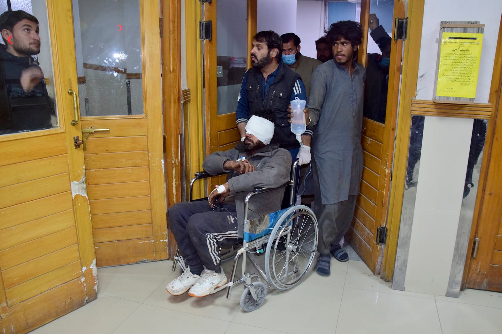 An injured victim of a passenger train attacked by insurgents, shifts to another ward after receiving initial treatment at a hospital in Quetta, Pakistan's southwestern Balochistan province, Thursday March 13, 2025. (AP Photo/Arshad Butt)