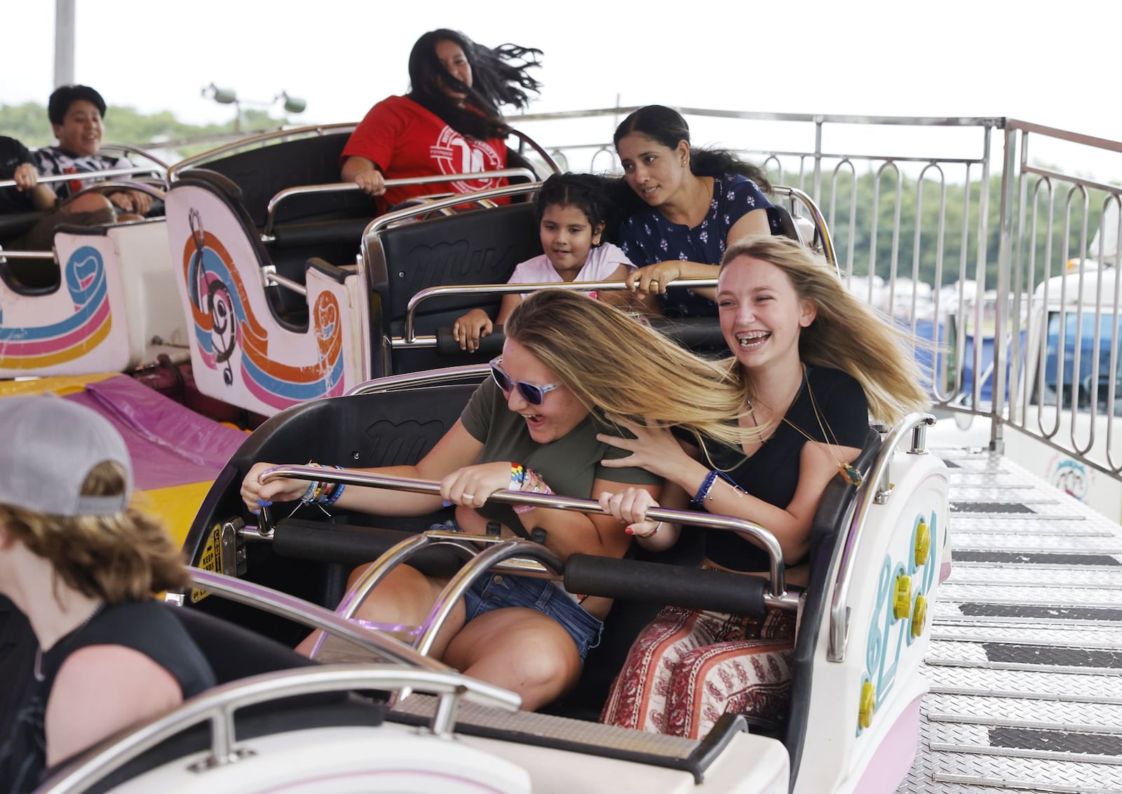 Lili Crites, 15, left, and Jayden Huening, 13, ride the Musik Express ride at the Butler County Fair Monday, July 25, 2022 in Hamilton. NICK GRAHAM/STAFF