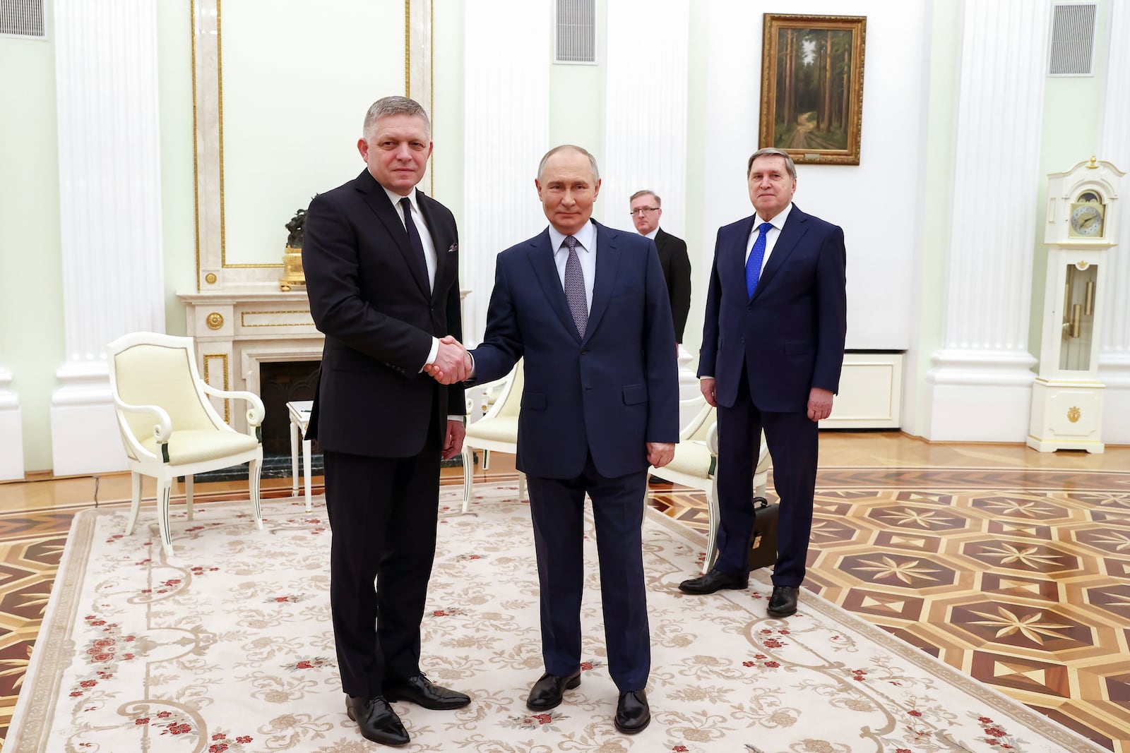 Russian President Vladimir Putin, foreground right, and Slovak Prime Minister Robert Fico pose for a photo during their meeting at the Kremlin in Moscow, Russia, Sunday, Dec. 22, 2024. (Artyom Geodakyan, Sputnik, Government Pool Photo via AP)