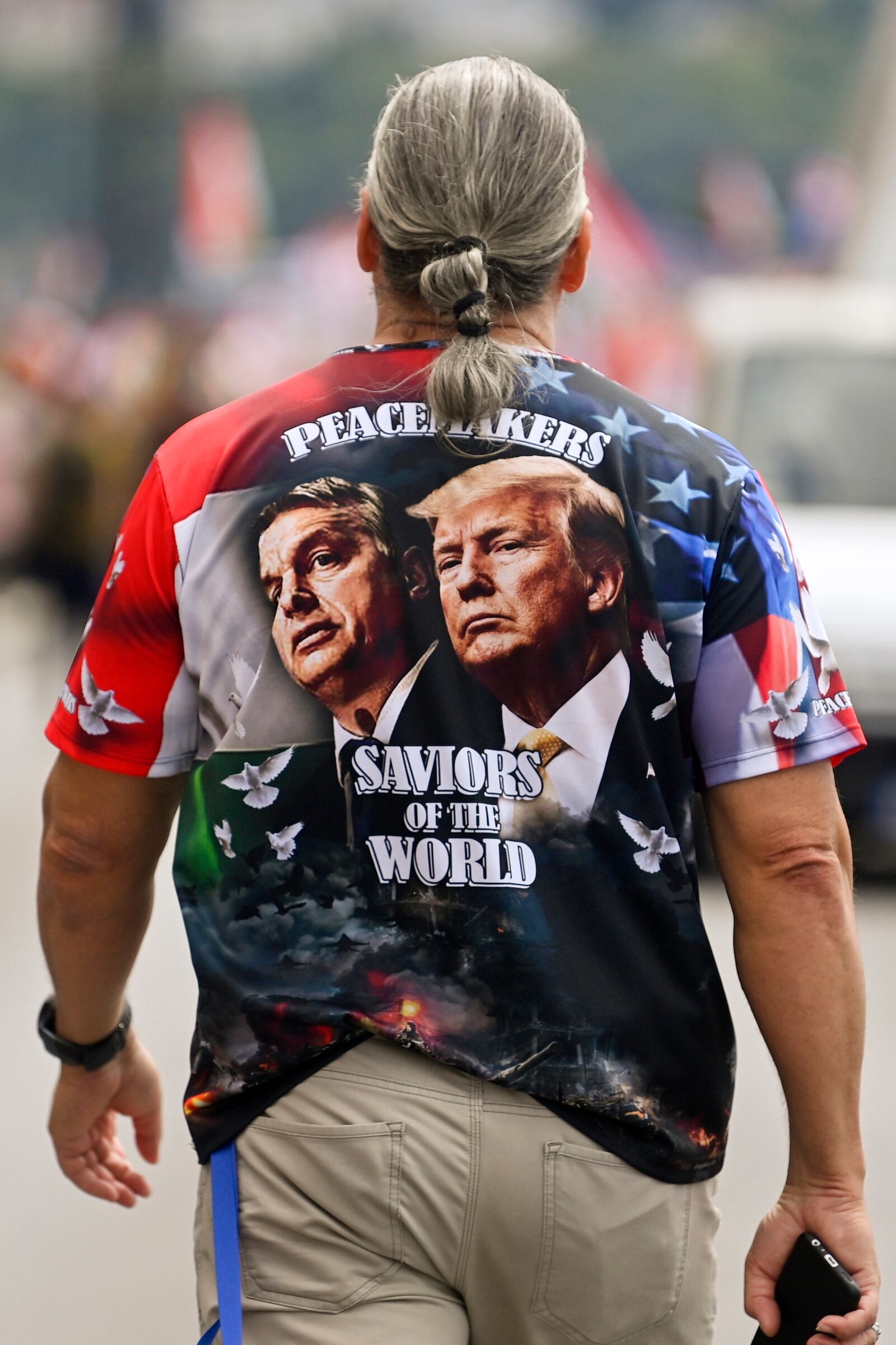 FILE - A man sports a shirt with the faces of Prime Minister of Hungary Viktor Orban, left, and Donald Trump as he participates in a march in Budapest, Hungary, June 1, 2024. (Zsolt Czegledi/MTI via AP, File)