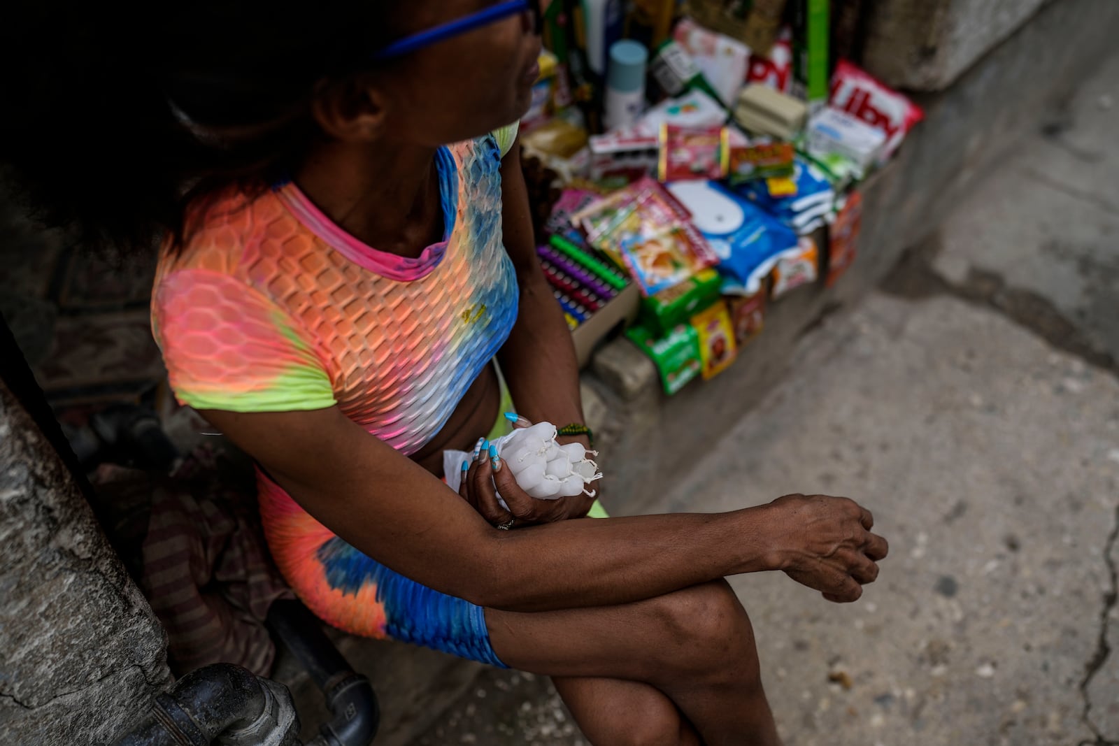 FILE - A street vendor selling candles waits for customers during a blackout following the failure of a major power plant in Havana, Cuba, Oct. 19, 2024. (AP Photo/Ramon Espinosa, File)