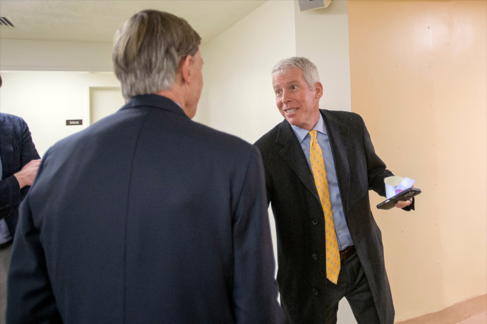 Chris Wright, President Donald Trump's nominee to be Secretary of Energy, right, talks with Sen. John Hickenlooper, D-Colo., left, as he makes his way through the Senate subway at the Capitol, Thursday, Jan. 23, 2025, in Washington. (AP Photo/Rod Lamkey, Jr.)