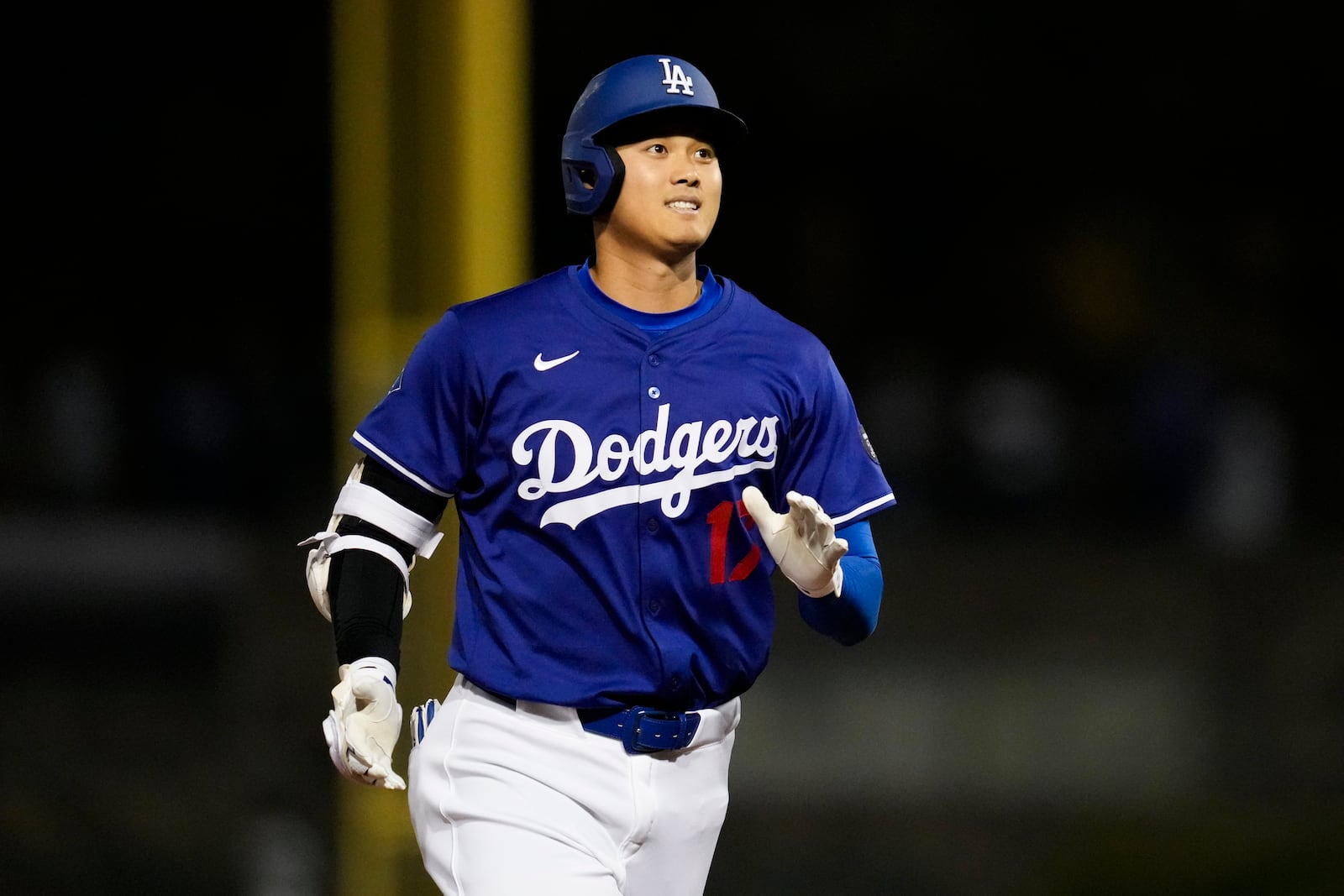 Los Angeles Dodgers designated hitter Shohei Ohtani reacts as he pops out to shortstop during the second inning of a spring training baseball game against the Los Angeles Angels, Friday, Feb. 28, 2025, in Phoenix. (AP Photo/Ashley Landis)