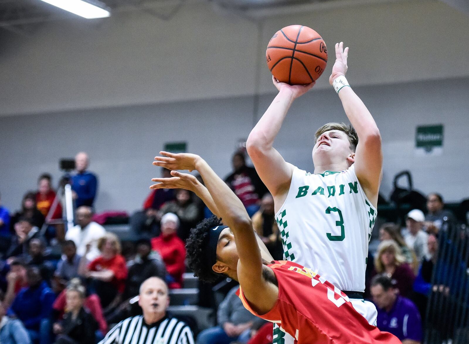 Badin’s Nathan Hegemann shoots over Purcell Marian’s Michael Little during Friday night’s game at Mulcahey Gym in Hamilton. Purcell won 64-52. NICK GRAHAM/STAFF