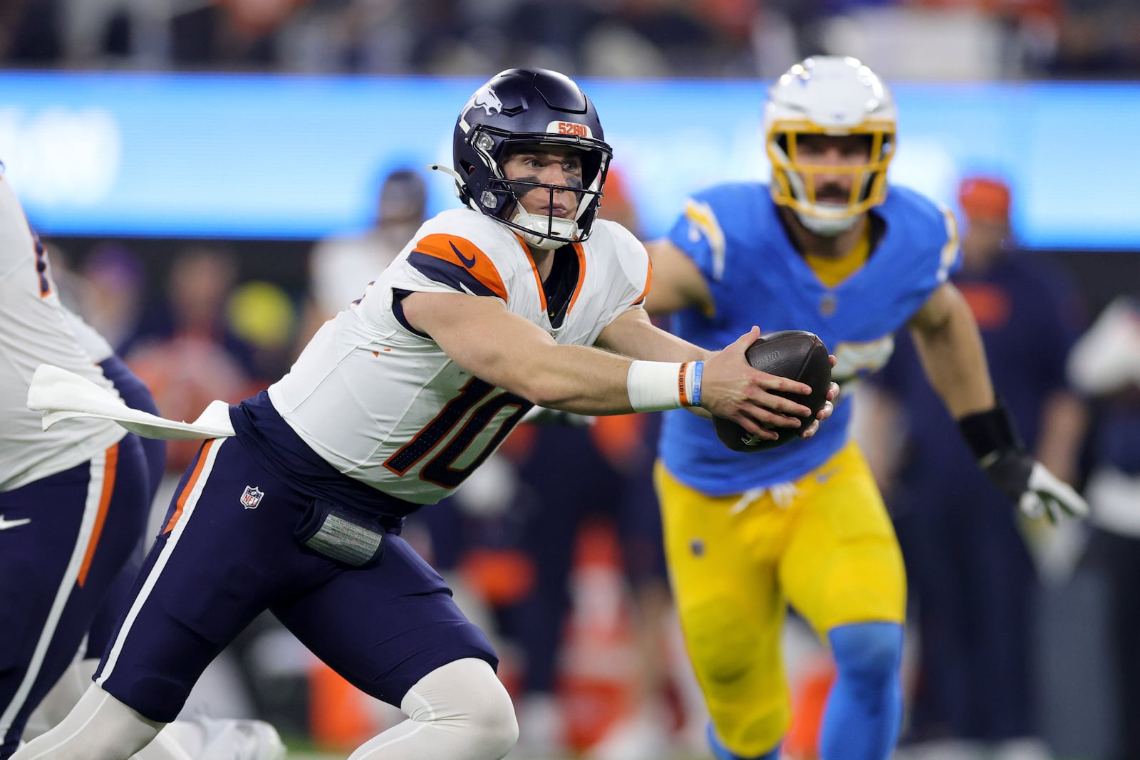 Denver Broncos quarterback Bo Nix (10) drops back to try a handoff during the first half an NFL football game against the Los Angeles Chargers, Thursday, Dec. 19, 2024, in Inglewood, Calif. (AP Photo/Ryan Sun)