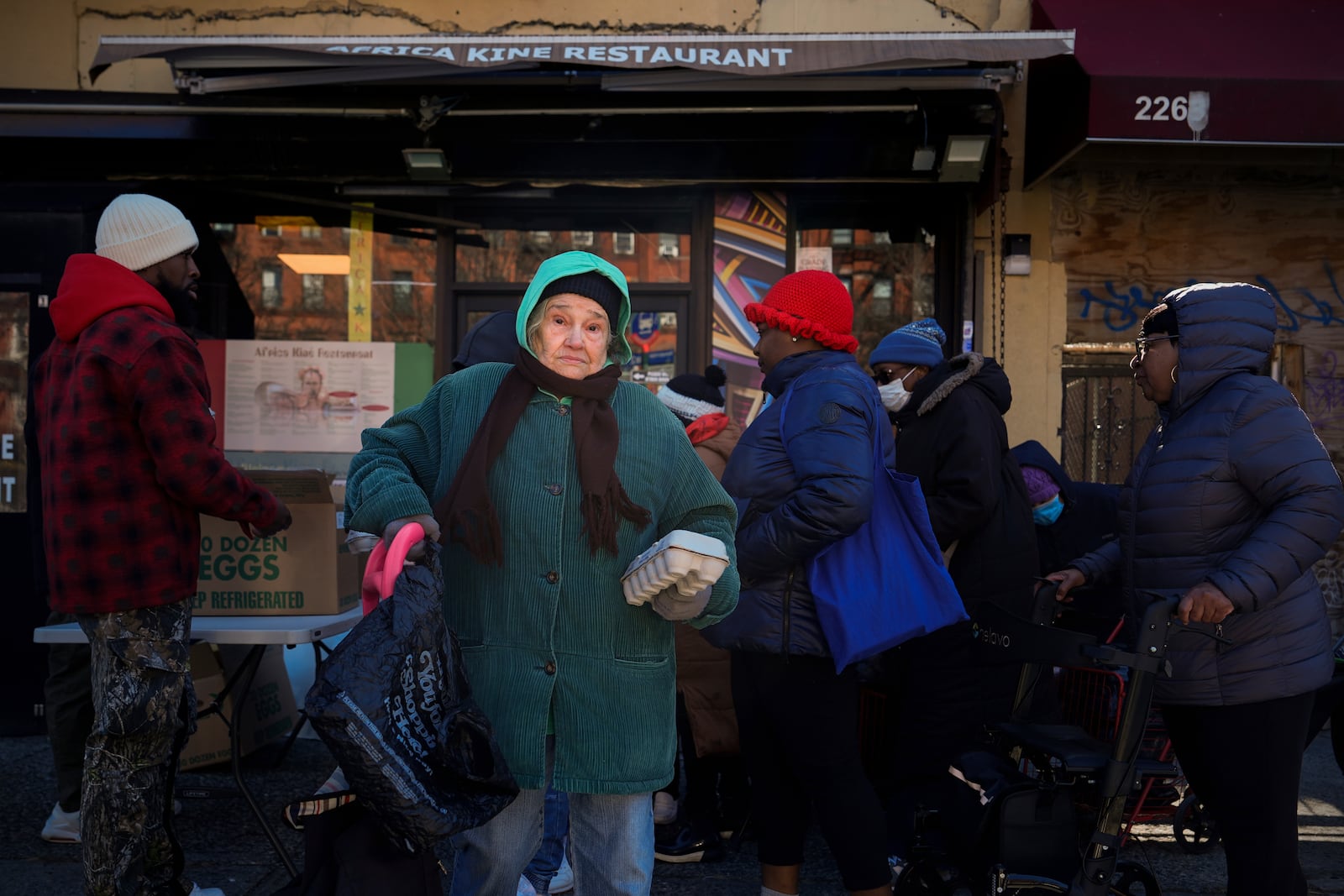 People leave after receiving a free carton of eggs from FarmerJawn Agriculture, Friday, March 21, 2025, in the Harlem neighborhood of New York. (AP Photo/Julia Demaree Nikhinson)