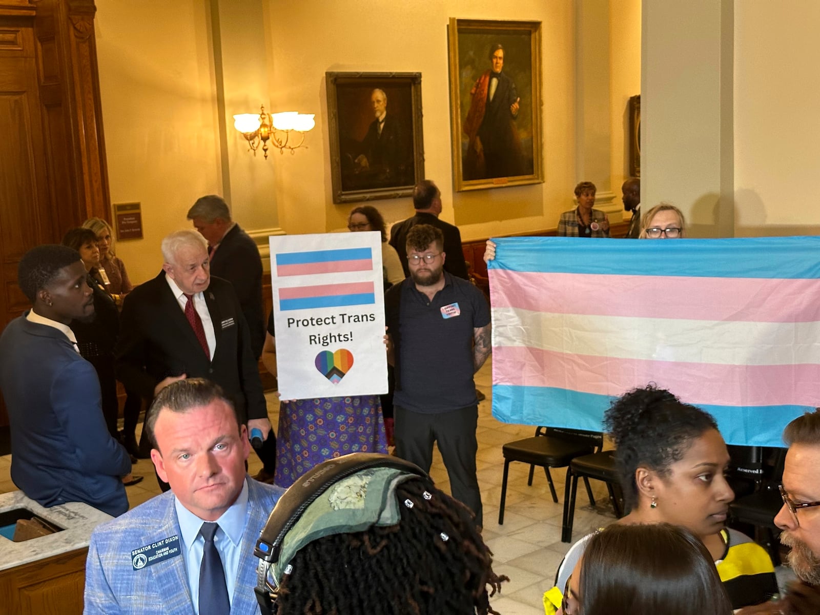 FILE - Georgia state Sen. Clint Dixon (R-Buford), left, front, talks to reporters after the passage of a bill that would ban transgender girls from playing high school sports on Tuesday, March, 26, 2024, at the Georgia Capitol in Atlanta. (AP Photo/Jeff Amy, File)