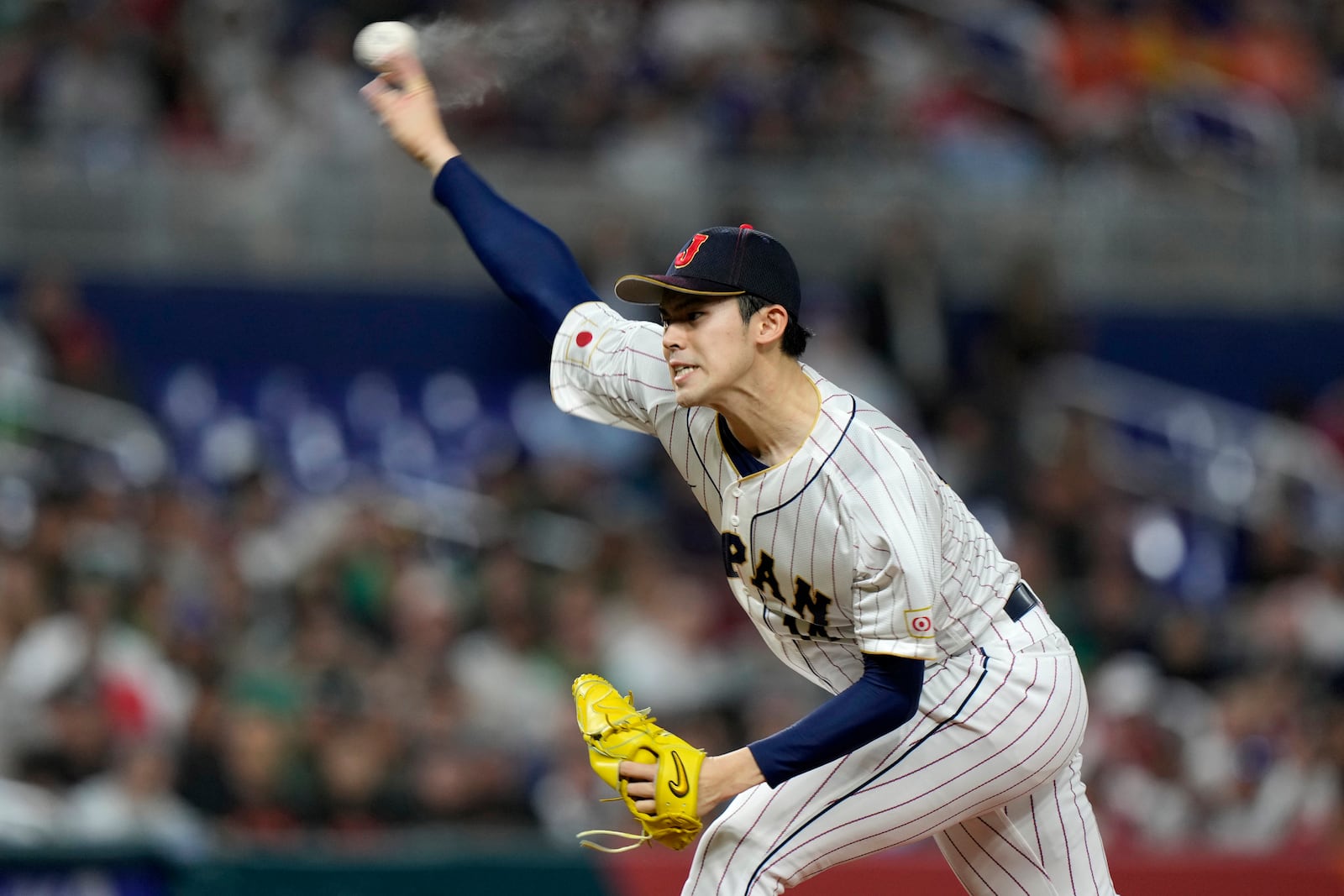 FILE- Japan's Roki Sasaki delivers a pitch during the first inning of a World Baseball Classic game against Mexico, March 20, 2023, in Miami. (AP Photo/Wilfredo Lee, File)